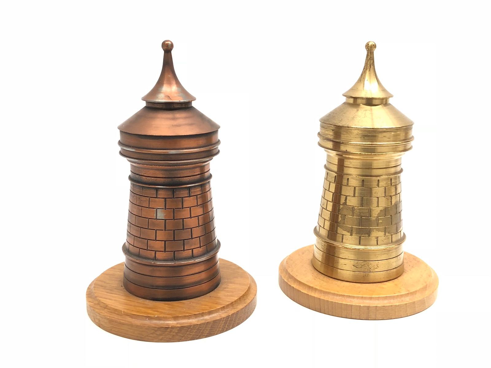 Two decorative Nuremberg City Tower souvenir building sculptures. Some wear with a nice patina, but this is old-age. Made of metal and a wooden base. These items were bought as a souvenir in Nuremberg, Germany and were made in the mid-20th century
