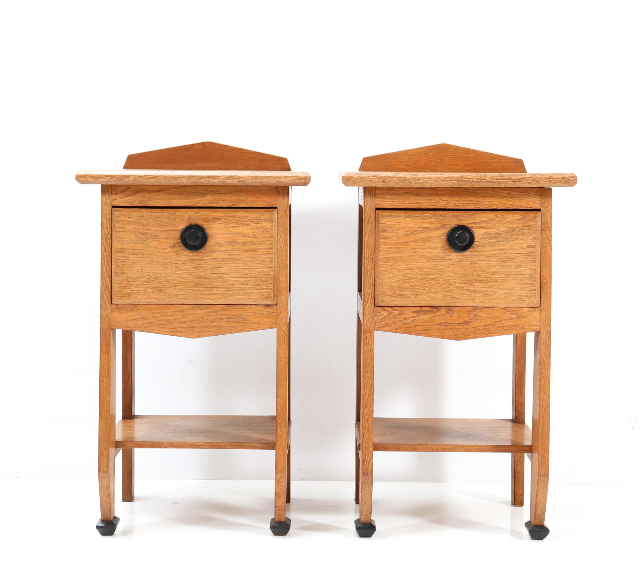 Magnificent and ultra rare pair of Art Deco Amsterdamse School nightstands.
The design is attributed to Jac. van den Bosch.
Striking Dutch design from the 1920s.
Solid oak frames and the drawers have the original ebony knobs.
Original black