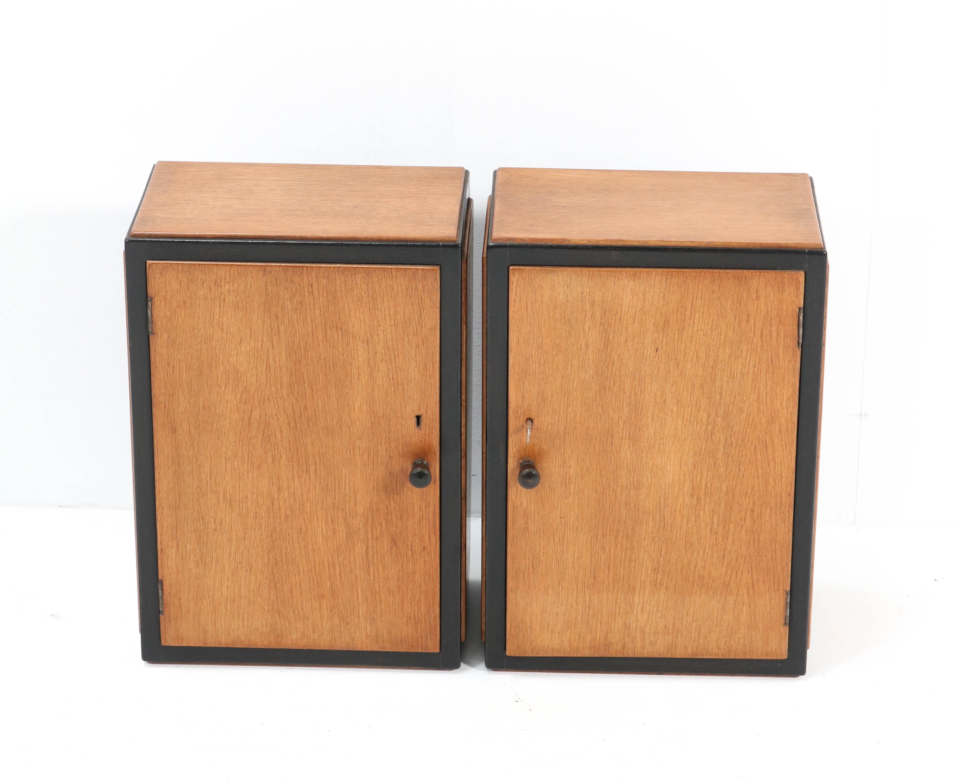 Wonderful and rare pair of Art Deco Haagse School wall cabinets.
Design by Meubelfabriek R.H. Nanninga Groningen.
Striking Dutch design from the 1920s.
Solid oak with oak veneer and original black lacquered lining.
 