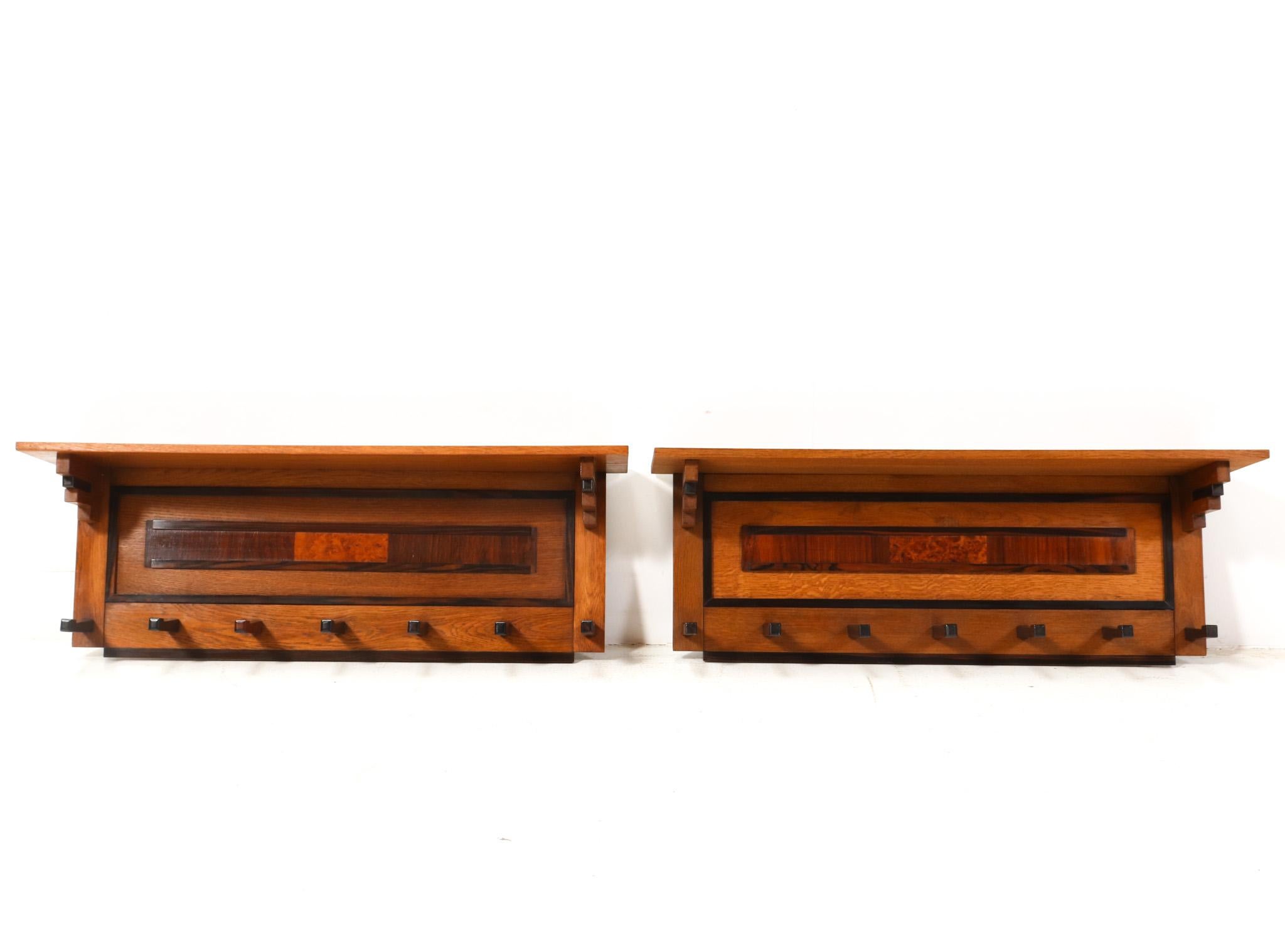 Stunning and rare pair of Art Deco Modernist coat racks.
Design by P.E.L. Izeren for De Genneper Molen.
Striking Dutch design from the 1920s.
Solid oak and original oak veneered frames with original walnut and macassar ebony veneered elements.
Each