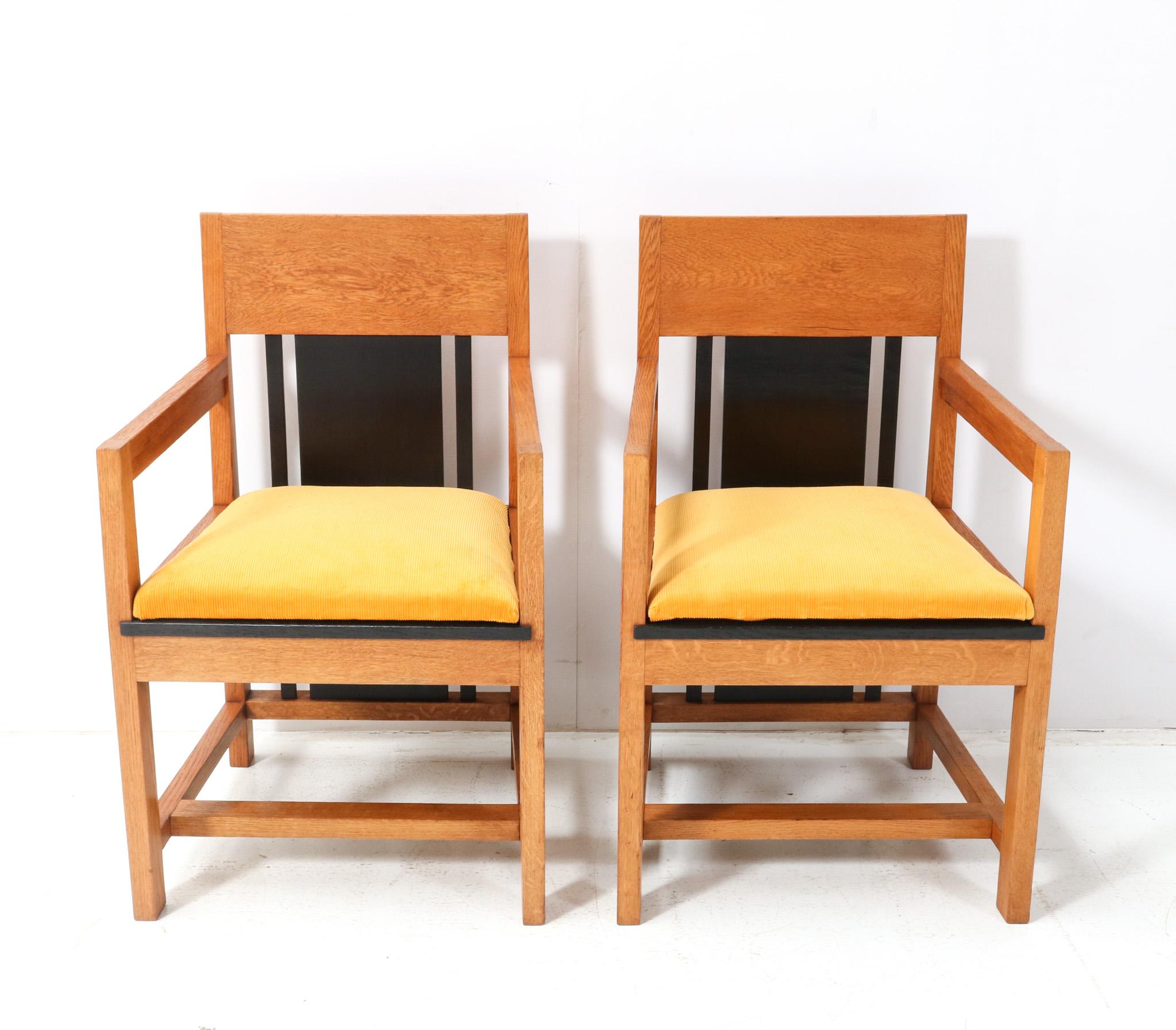 Magnificent and ultra rare pair of Art Deco Modernist high back armchairs. Design by Cor Alons and executed by Fa. Winterkamp & Van Putten in 1927. Striking Dutch design from the 1920s. Solid oak and black lacquered base with original black