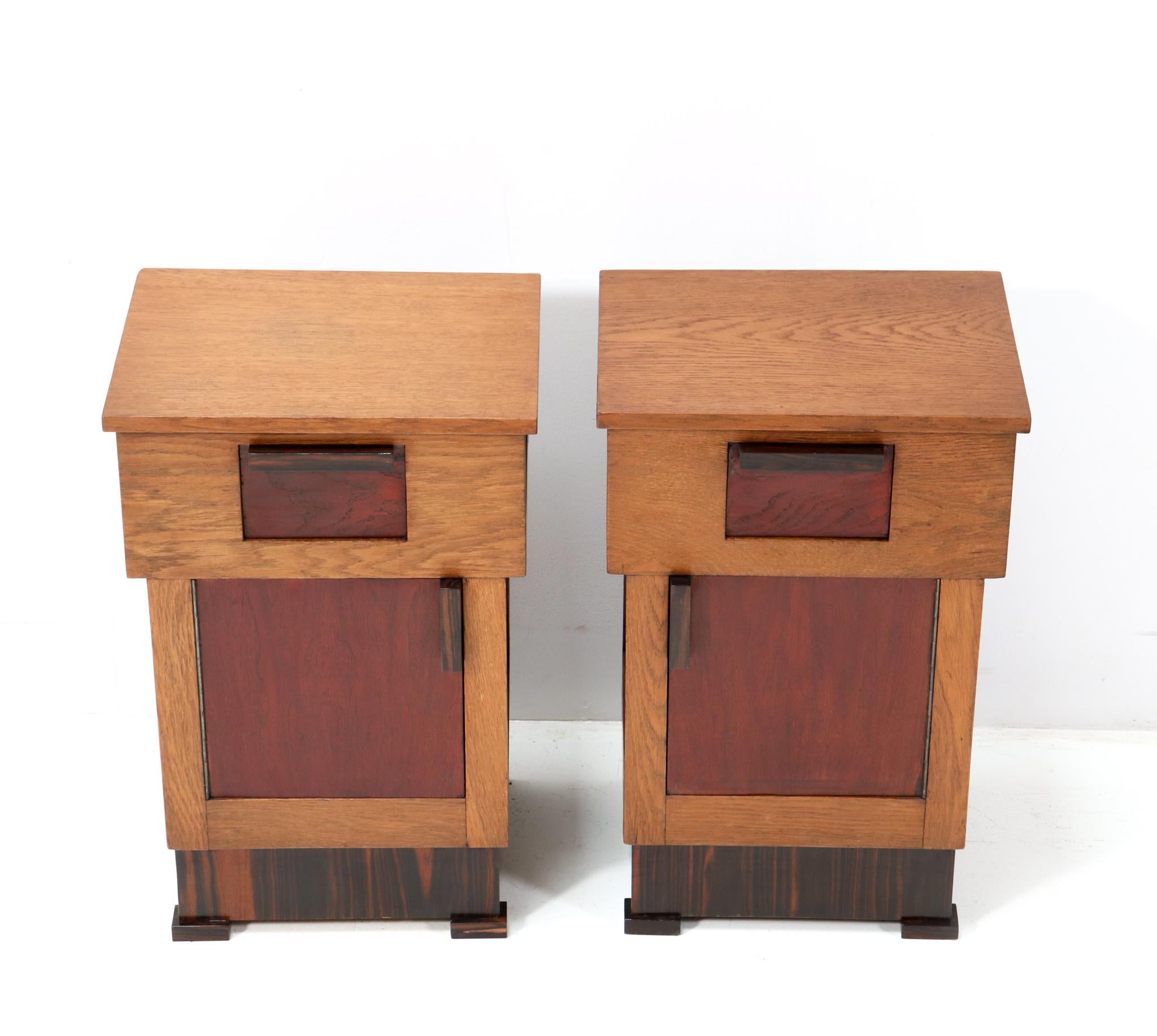 Magnificent and rare pair of Art Deco Modernist nightstands or bedside tables.
Striking Dutch design from the 1920s.
Solid oak with original solid macassar ebony handles on the drawers and doors.
The drawers and doors are veneered with original