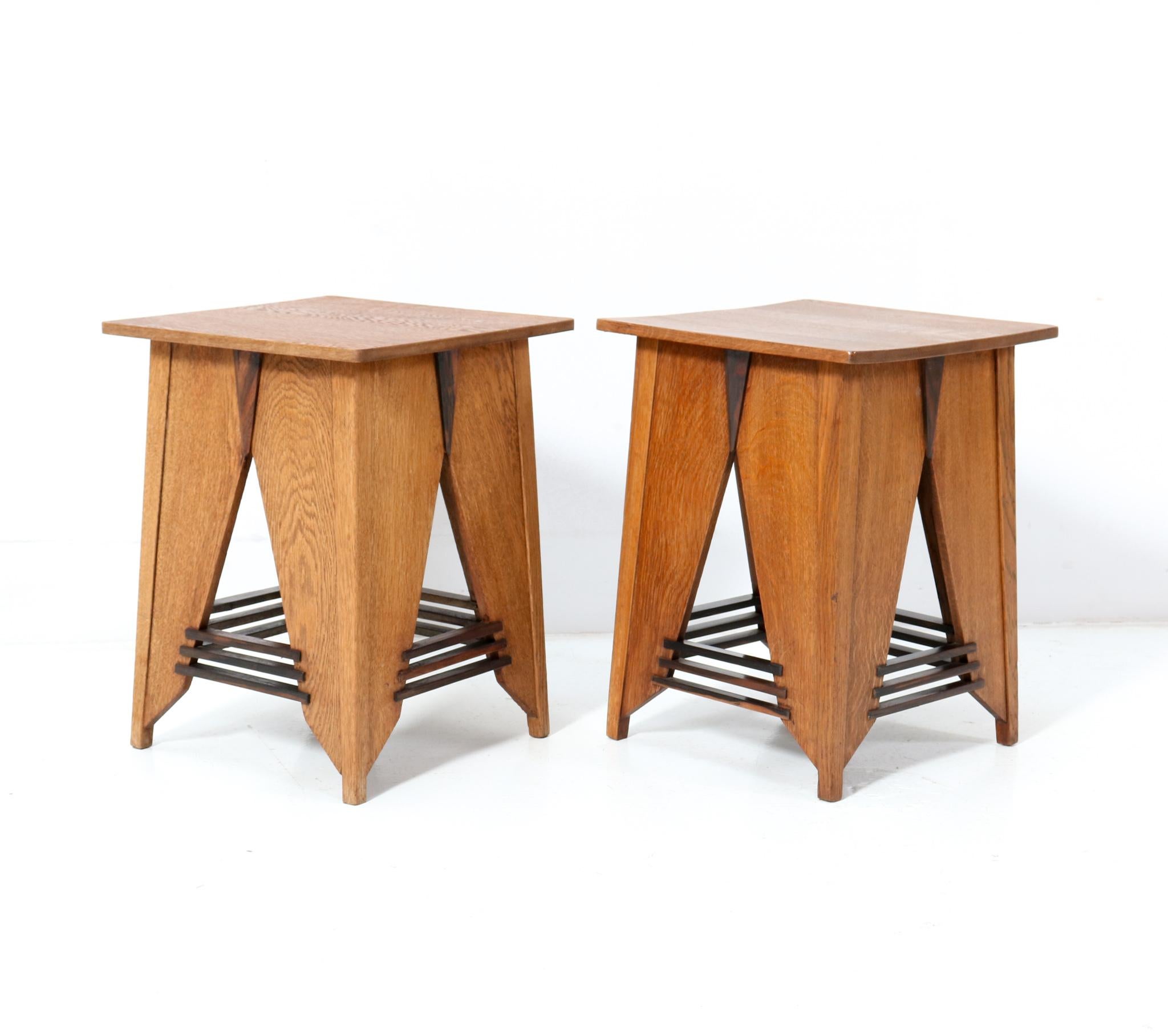 Magnificent and rare pair of Art Deco Modernist side tables.
Design by P.E.L. Izeren for De Genneper Molen.
Striking Dutch design from the 1920s.
Solid oak base with original solid macassar ebony elements.
Solid oak table tops.
In very good