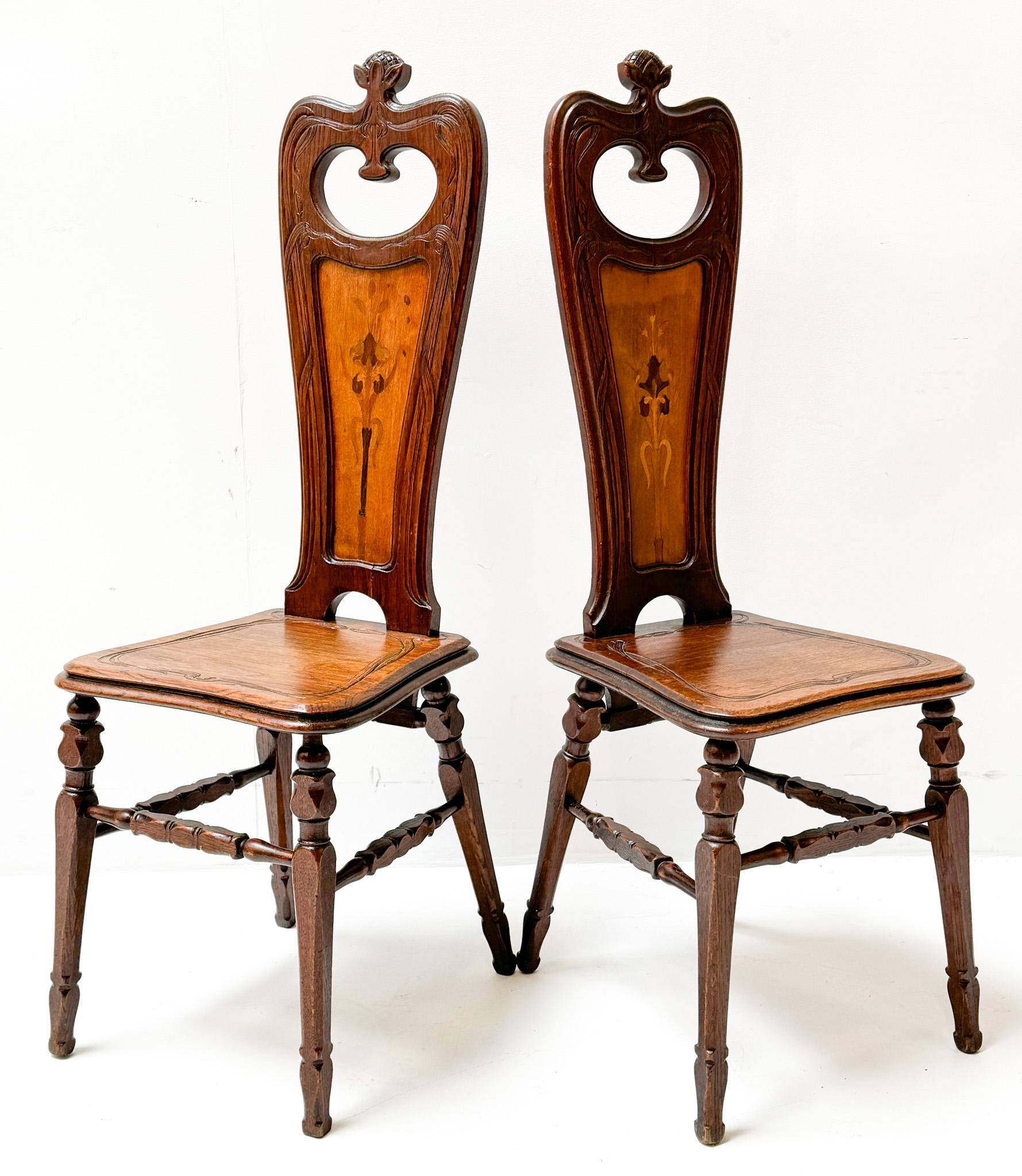 Magnificent and rare pair of Art Nouveau side chairs.
Design by Emile Gallé.
Striking French design from the 1890s.
Solid oak frames with original sycamore decorations of flowers in the backsides.
This wonderful pair of Art Nouveau side chairs by