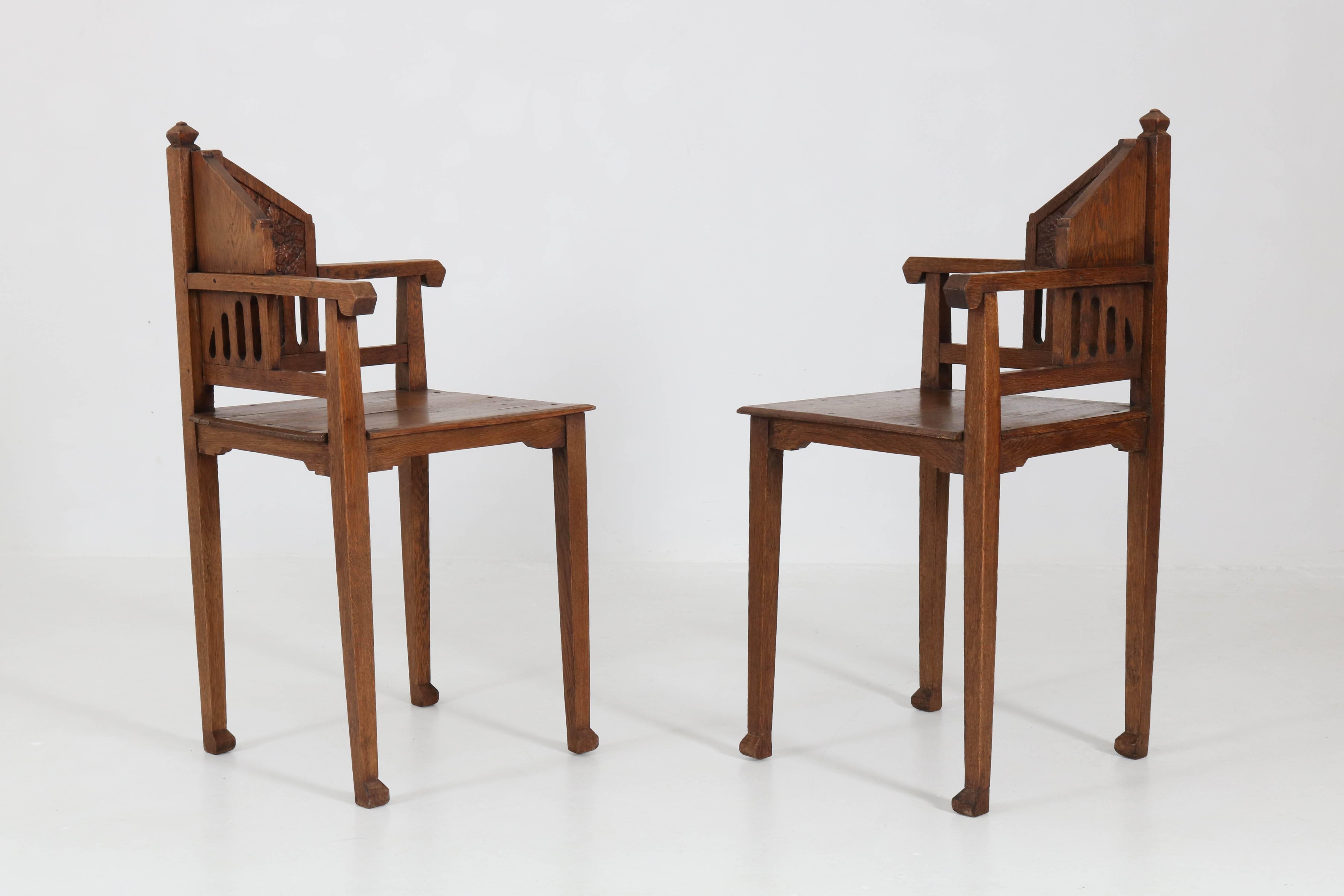 Elegant and rare pair of Dutch Arts & Crafts Art Nouveau corner chairs, 1900s.
Solid oak with nicely carved decoration.
In good original condition with minor wear consistent with age and use,
preserving a beautiful patina.
  