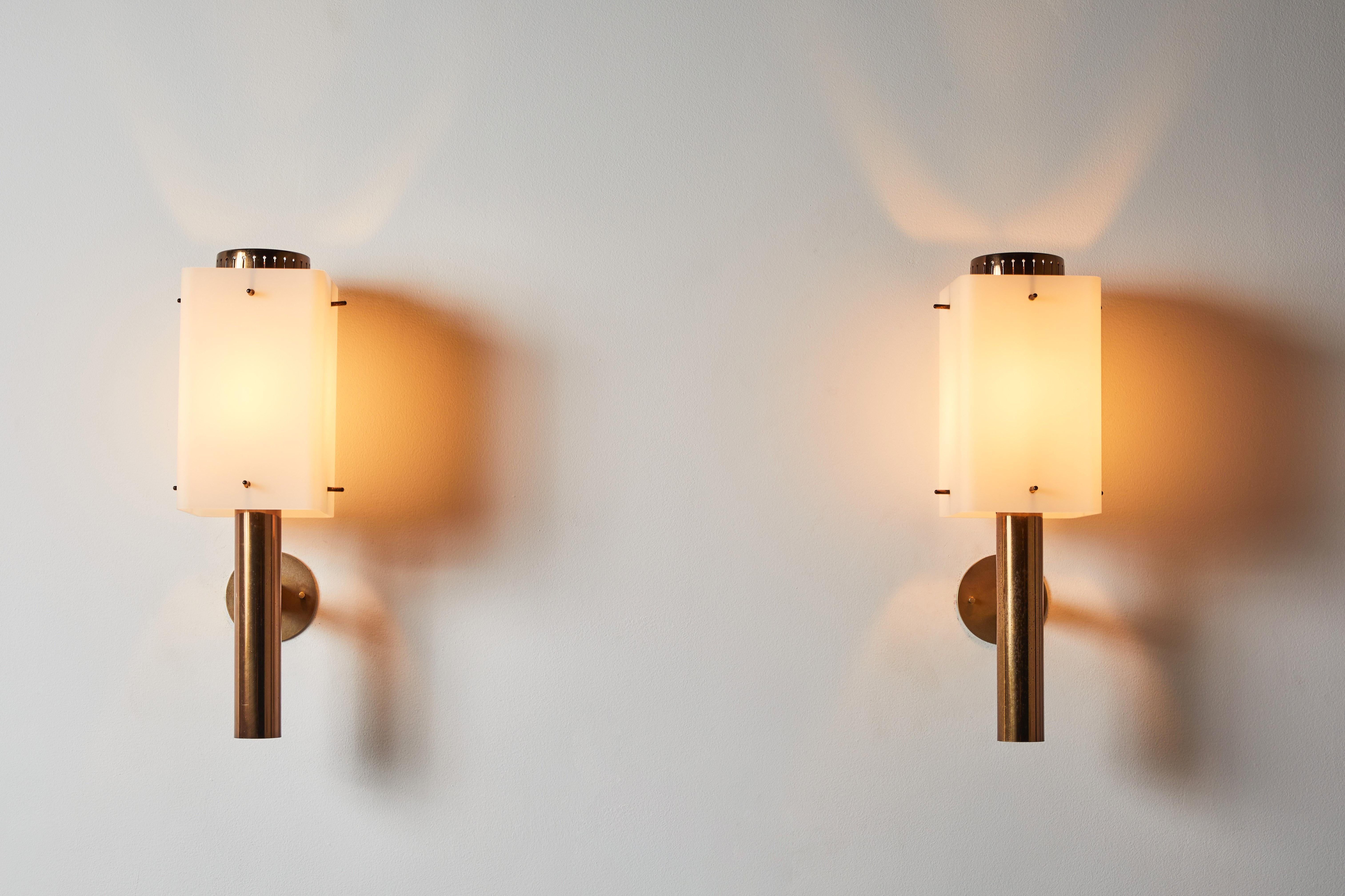 Two pairs of sconces by Stilnovo. Manufactured in Italy, circa 1960s. Brushed satin glass diffuser with brass frame, custom brass back plates. Rewired for U.S. junction boxes. Each light takes one E27 100w maximum bulb. Bulbs provided as a one time
