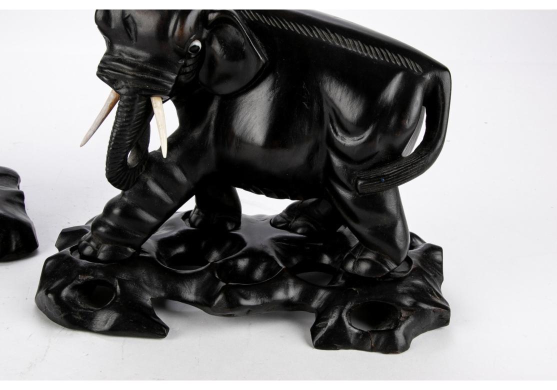 Two Opposing Ebonized Elephant Figures With Stands For Sale 1