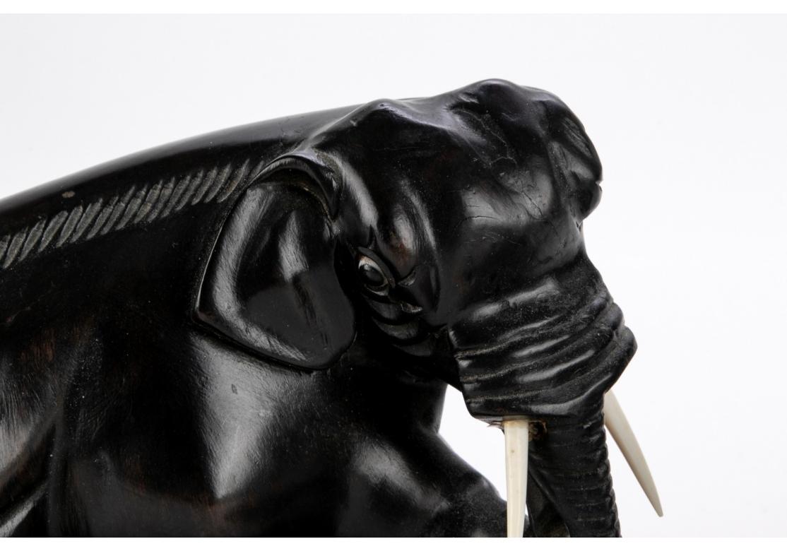 Two Opposing Ebonized Elephant Figures With Stands For Sale 2