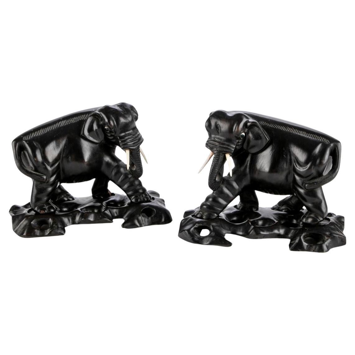 Two Opposing Ebonized Elephant Figures With Stands For Sale