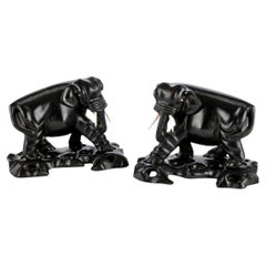 Two Opposing Ebonized Elephant Figures With Stands