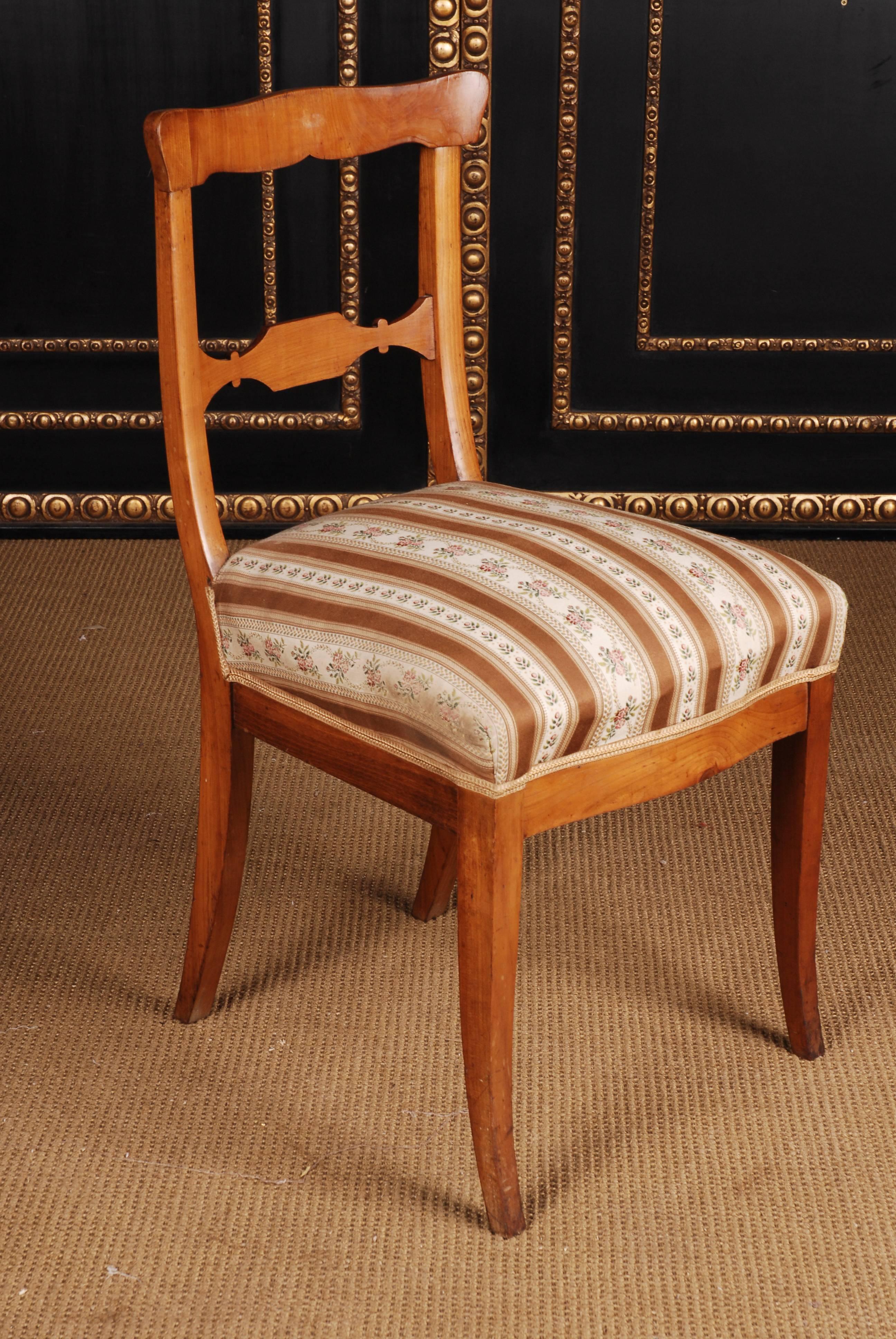 Cherry tree, straight frame on flared, conical legs. High-backed backrest frame with straight edge and corresponding middle web. Seat padded with spring core.

A good historical condition with a beautiful warm patina.
 