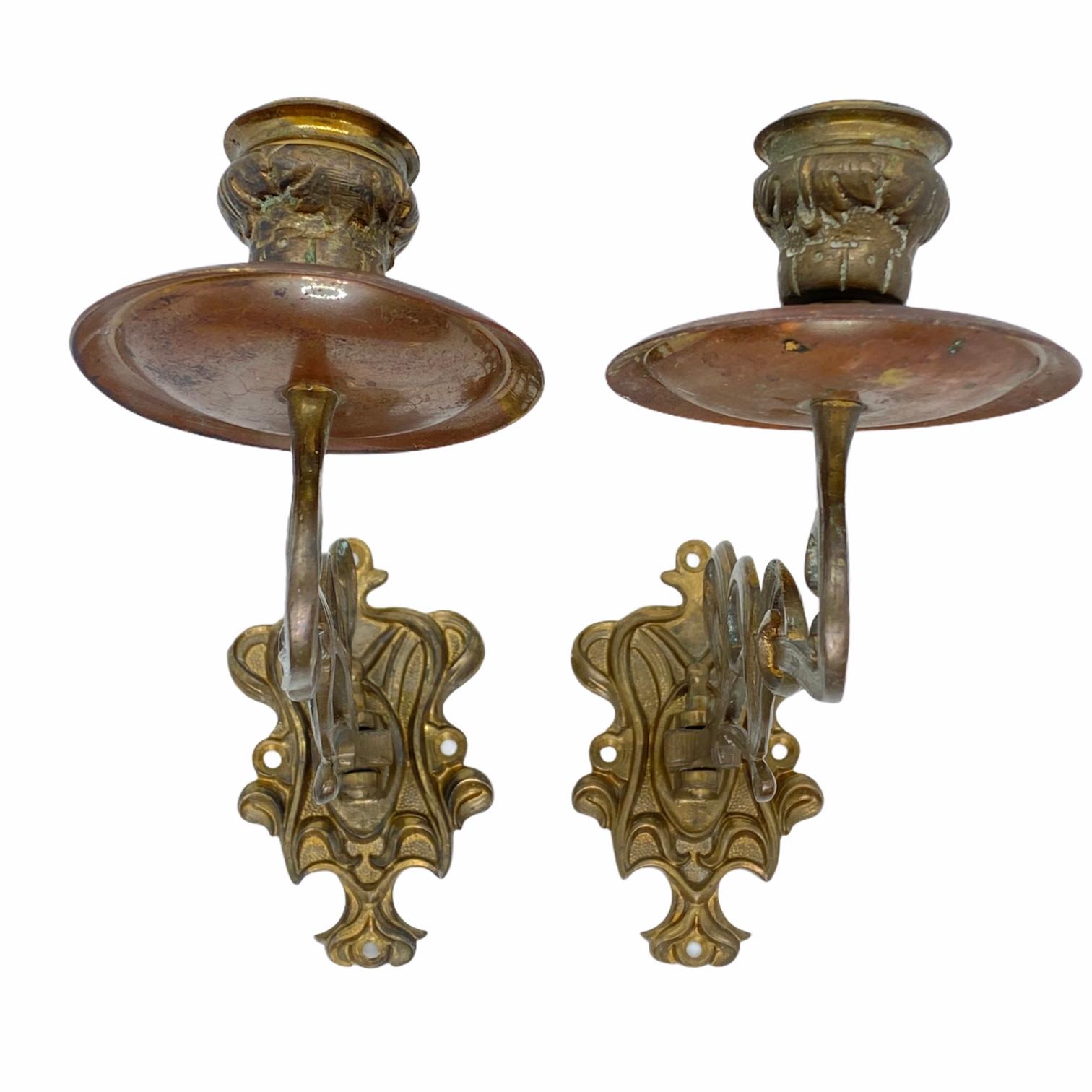 This is a 1890s pair of arm candle piano or wall sconces. Nice patina to the metal and an all original condition.