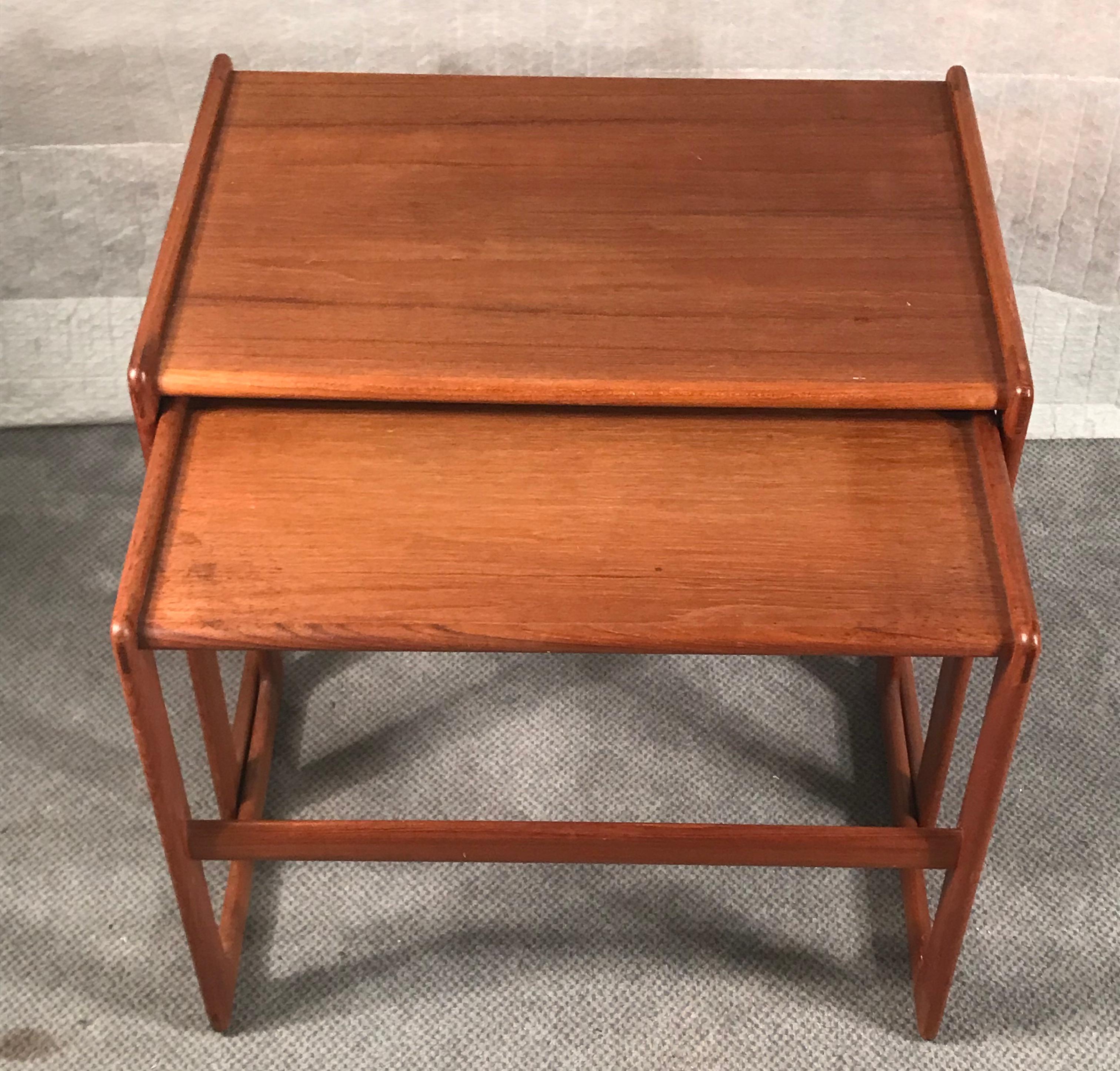 Two original mid-century nesting tables by Morgen-Kohl, Denmark 1960's.
The two rectangular tables have a typical clean mid-century design and are made of solid teakwood. 
The tables have the original MK label. 
They are in very good original