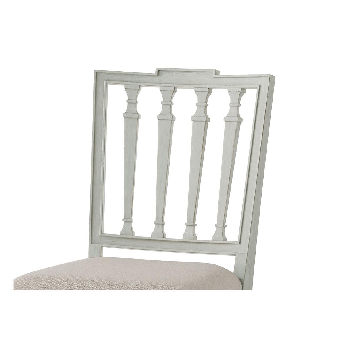 hand-carved from beech, painted in our Elsa finish and has a square crested back with tapered pilaster carved slats with an upholstered seat and raised on square tapering legs. Shown in Draper performance fabric.

Dimensions: 18.5