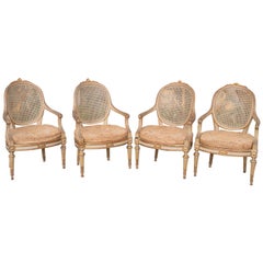 Dos parejas de sillones dorados y pintados del siglo XIX
