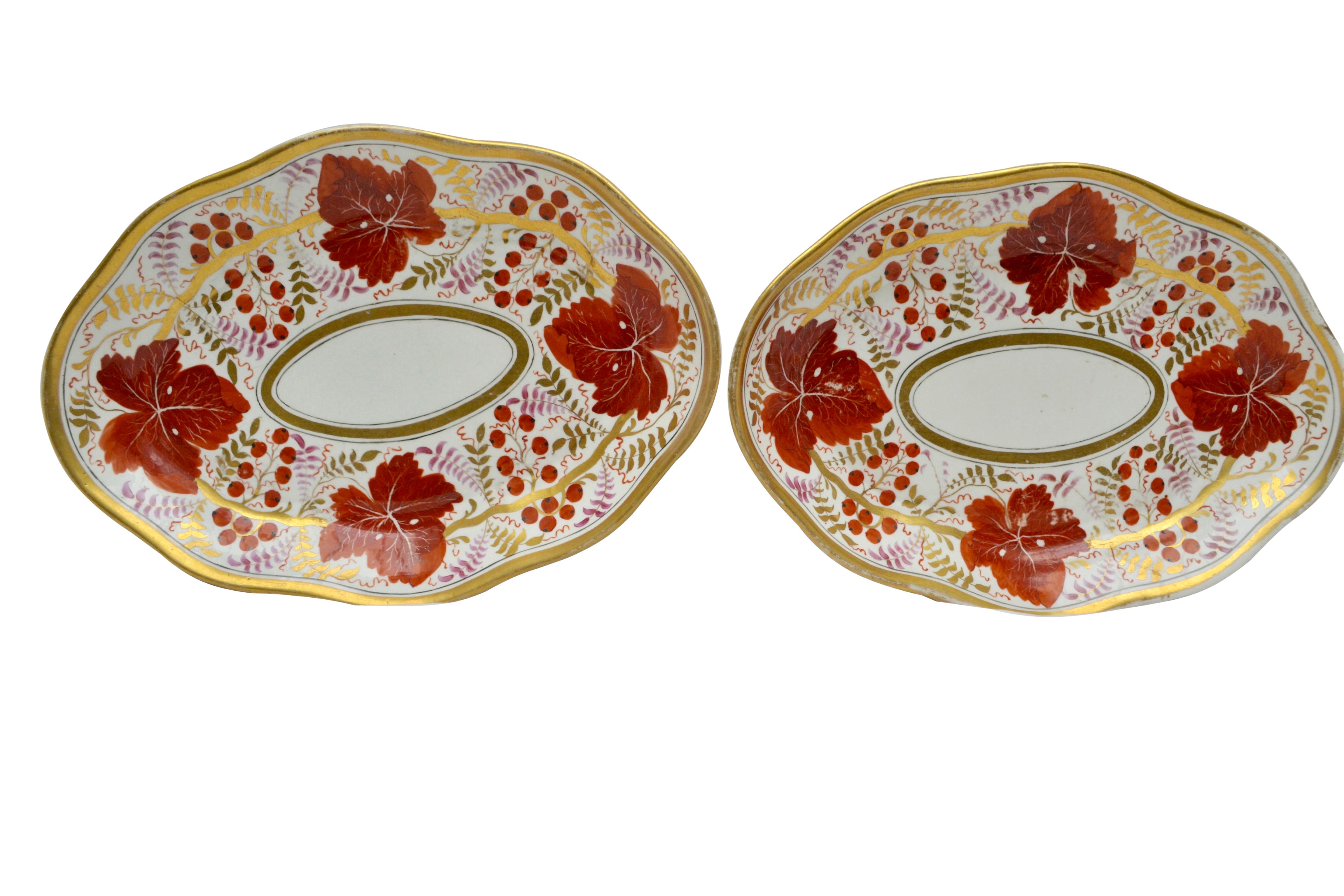 Two pairs of coral, white and gilded oval shaped Coalport serving dishes English, circa 1820. Measurements for the pair with orange ivy leaves 11.5? L x 8? W x 1.75? H Some rubbing of the gilding but no cracks or repairs on this pair. Measurements