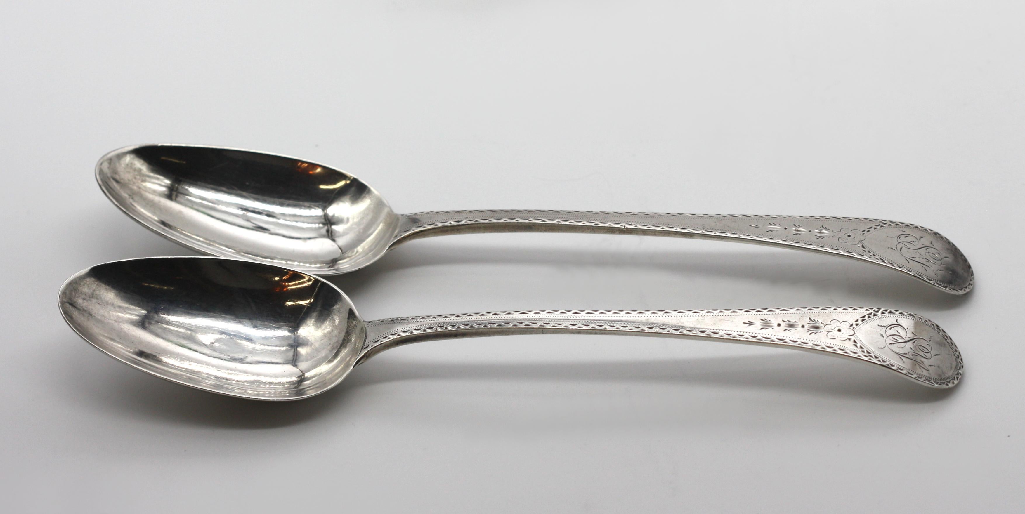
Two Pairs of English Silver Serving Spoons.
Late 18th Century, marked, maker probably, Samuel Wintle. The first pair with one spoon cast with short prongs, with the handle incised with a bull-headed device, the second pair, monogramed, and with