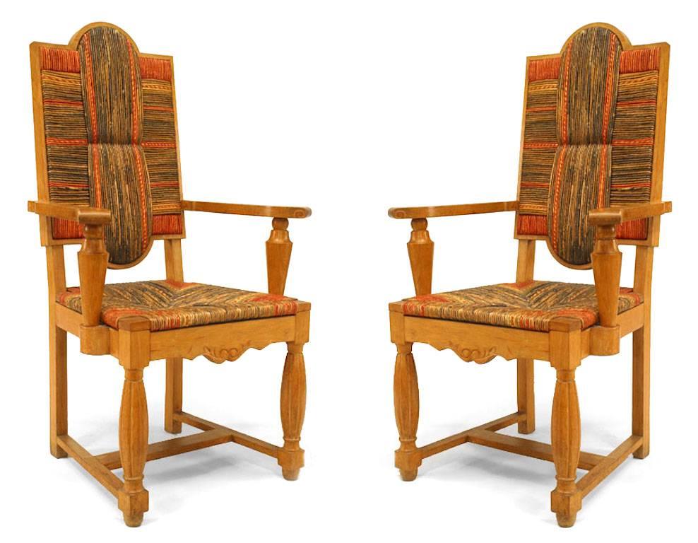 Two pairs of French 1940s oak Louis XIV style arm chairs with natural, red, and multicolored sea grass back and seat  (att: ANDRE ARBUS, ref: pg 205). Priced each.

André Arbus was a French furniture designer, sculptor and architect. Arbus exhibited