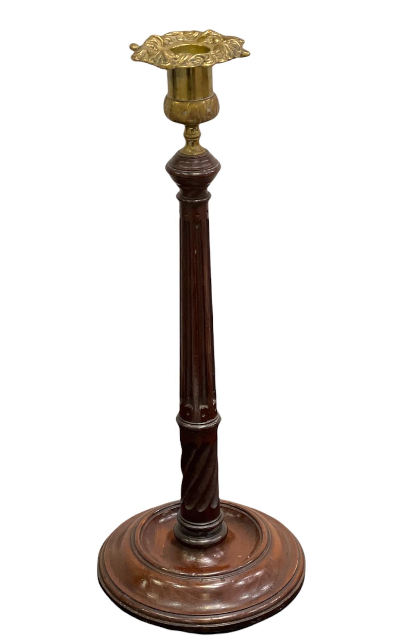 Two pairs of George II (18th Century) Mahogany and Brass Candlesticks. The brass candle sconces on top of spiral fluted tapered wood columns and molded circular bases.
 