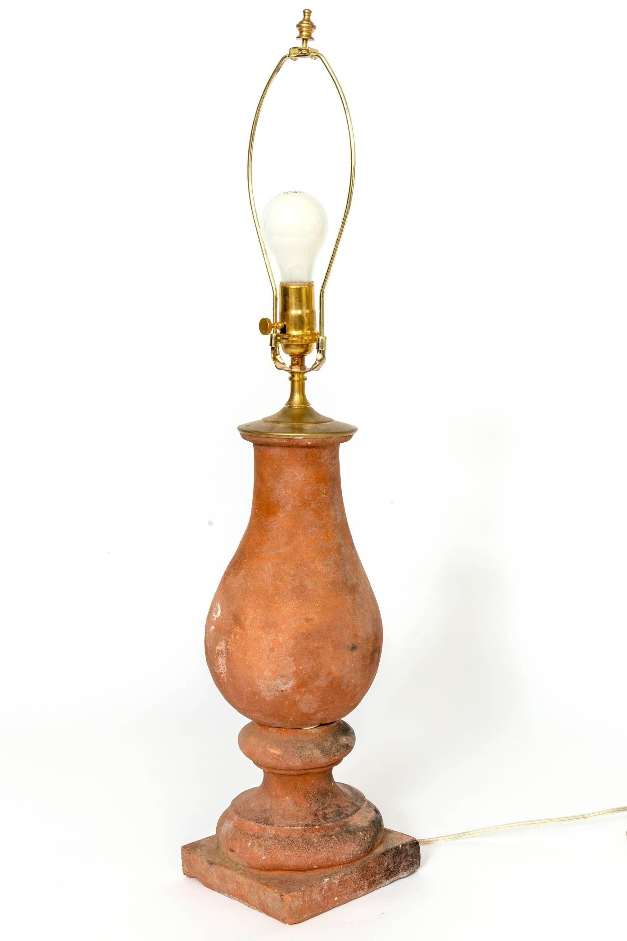 Pairs of hand molded red terra cotta table lamps.
Height given is to the top of the terra cotta, does not include any hardware.
The base of the lamp is 6.25 x 6.25