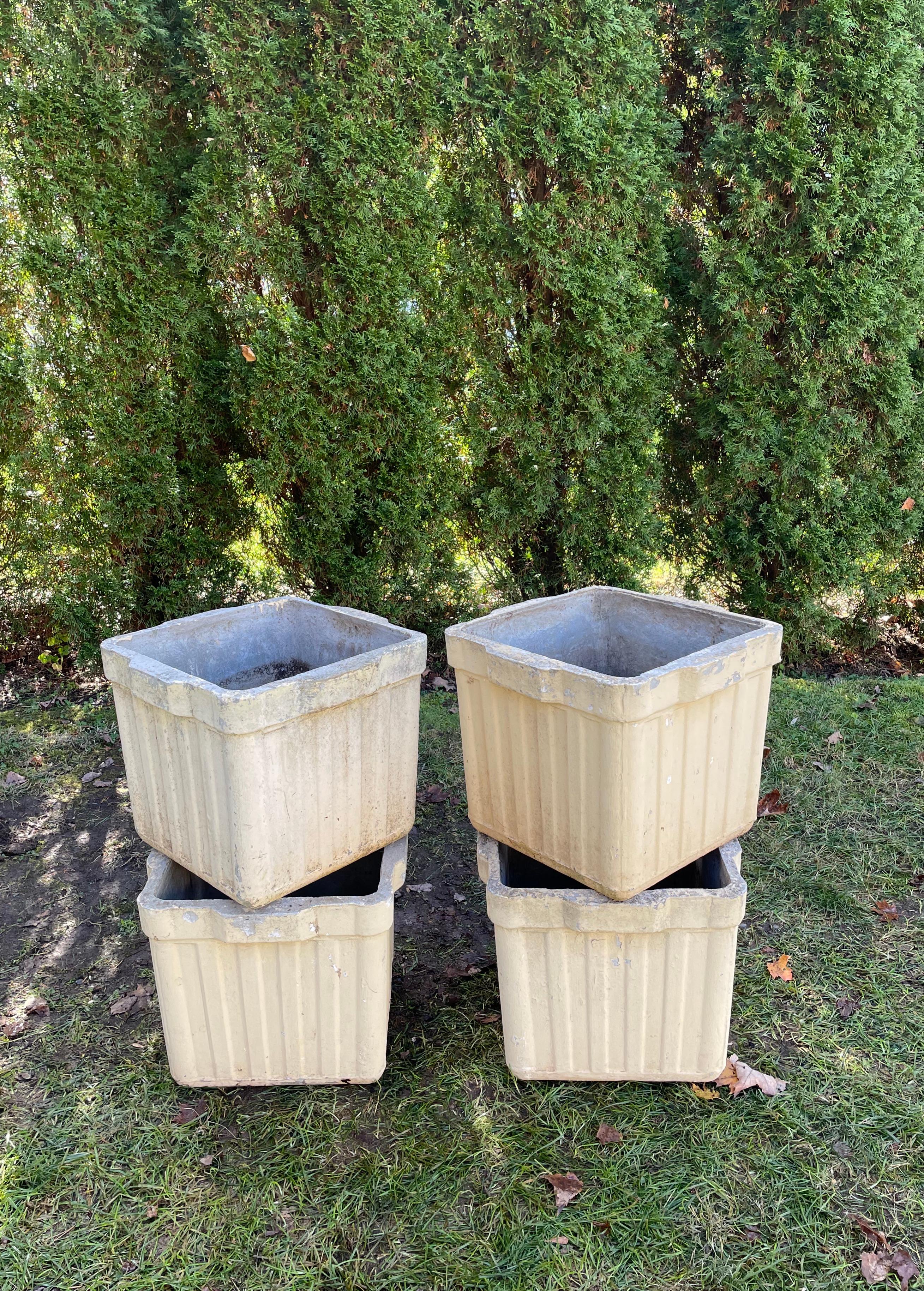 Designed by the iconic Willy Guhl in the 1960s and made of strong and lightweight fiber cement by Eternit, SA of Switzerland, these square ribbed planters sport a cream colored painted surface with pale yellow undertones and are in excellent