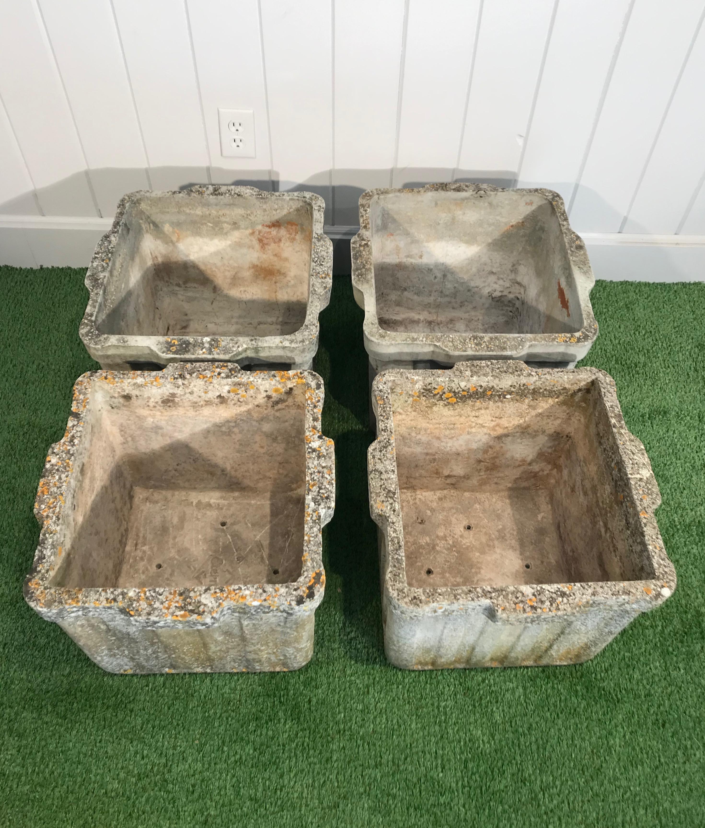 These ribbed planters with integral handles on two sides were designed by the iconic Willy Guhl and produced by Eternit of Switzerland in three sizes. These are the medium-sized ones. In very good structural condition, they feature a beautiful