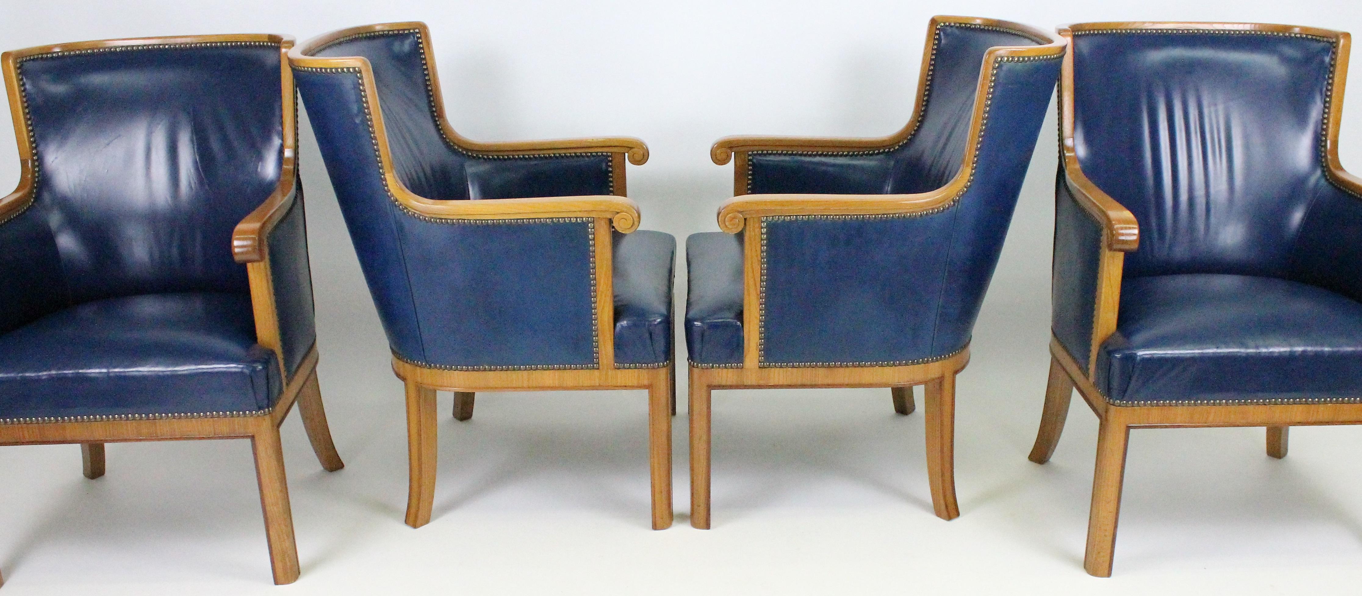 Two amazing pairs of armchairs. Made by Swedish firm Bodafors in the early 1930s. Royal blue leather with brass nails, elm, and walnut. The quality is the very best and the condition is really good. There is only some minor wear on the leather and