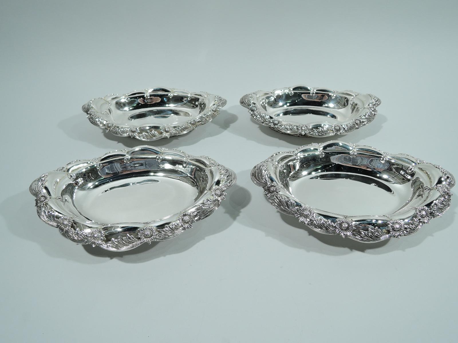 Two pairs of Chrysanthemum sterling silver serving bowls. Made by Tiffany & Co. in New York. Each: Oval well and turned-down petal rim in alternating leaf and flower head pattern. Short foot with applied scrolls. Restrained and elegant pieces in the