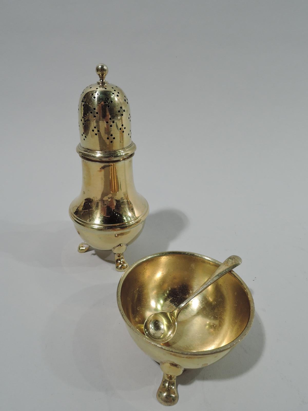 Two pairs of American gilt sterling silver open salts and pepper shakers. Made by Tiffany & Co. in New York. Each salt: Hemispheric bowl with hoof supports. Each pepper: Baluster with 3 hoof supports; cover domed with ornamental piercing and ball