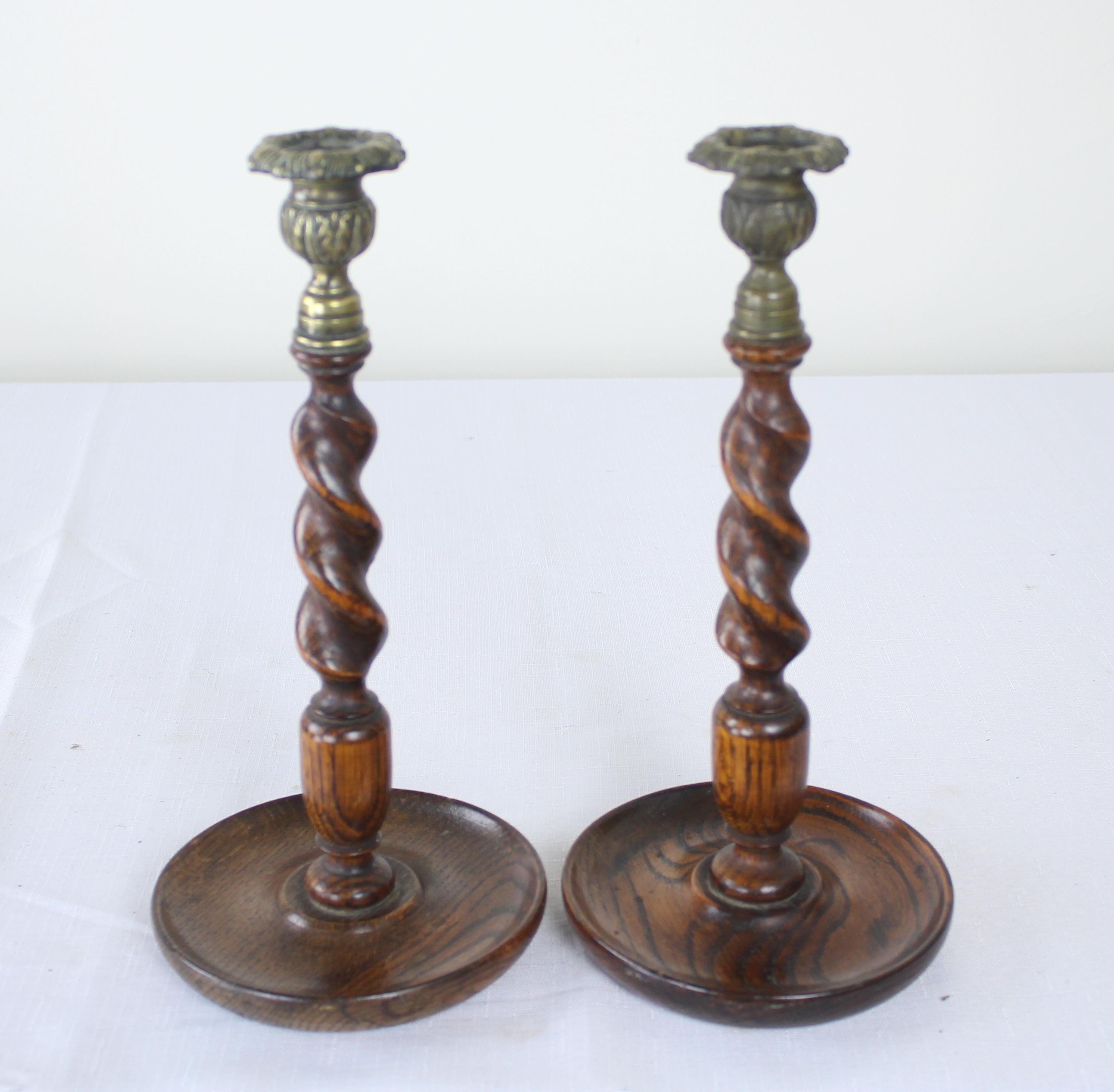 Two pairs of oak candlesticks, England, circa 1900. Heights vary from 10-12