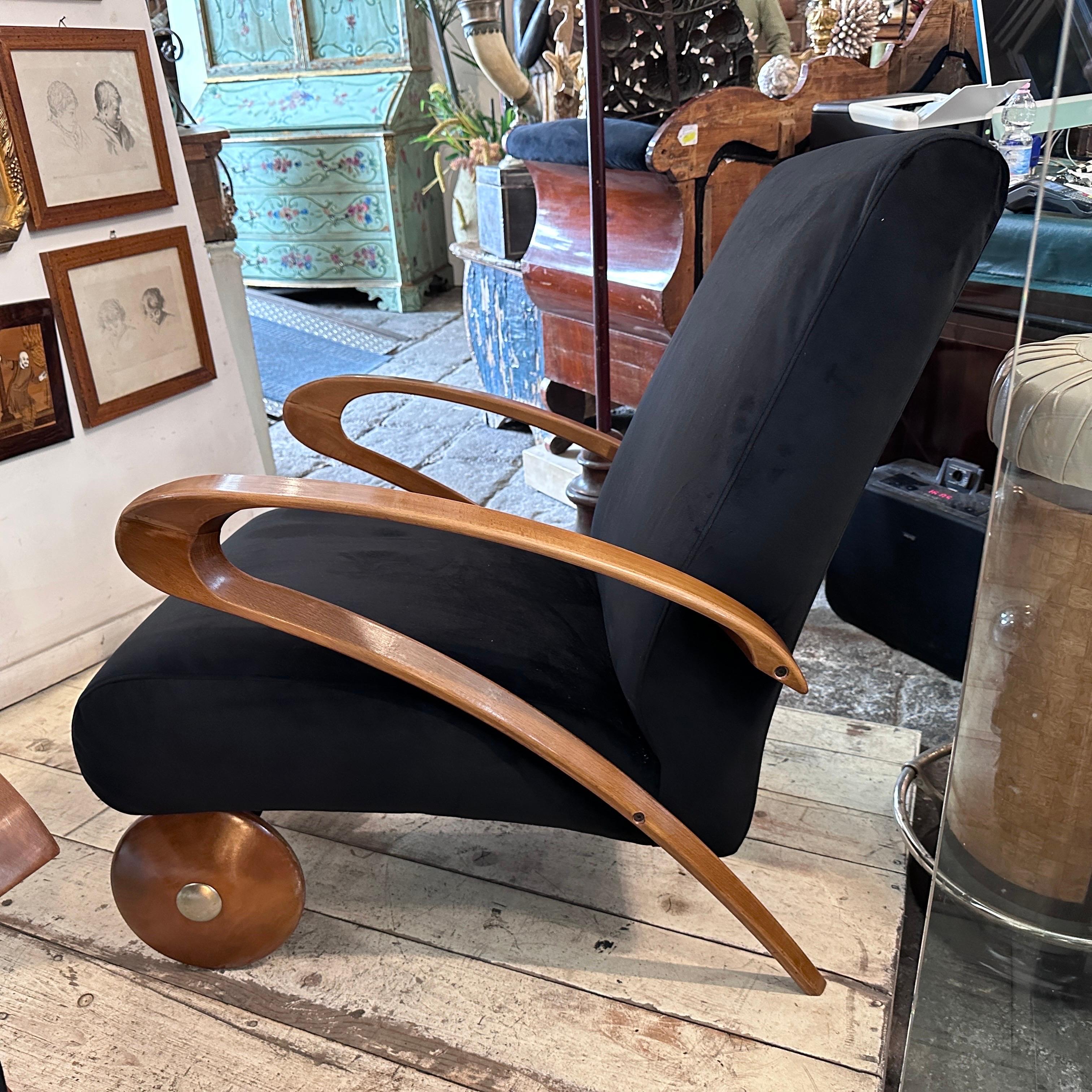 Two recently upholstered black velvet and wood armchairs designed and manufactured in Italy in the Seventies in the manner of Paolo Buffa. They are equipped with wheels and an aluminum handle in the back to be easily moved. These Armchairs are