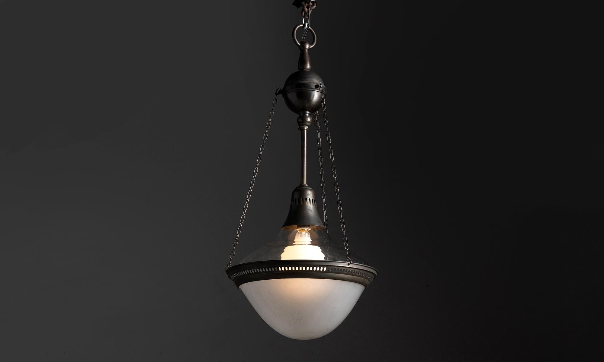 Two part AEG pendant with brass finish

Germany, circa 1910

Clear glass upper shade with opaline glass lower shade and original metal hardware.

Measures: 16” diameter x 32” height ( overall ).