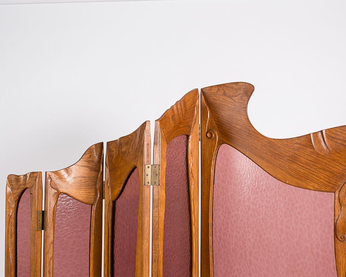 This screen executed in oak and pink frosted glass was an original design intended for the Casa Milà in Barcelona, one of Gaudí's last public works.
  