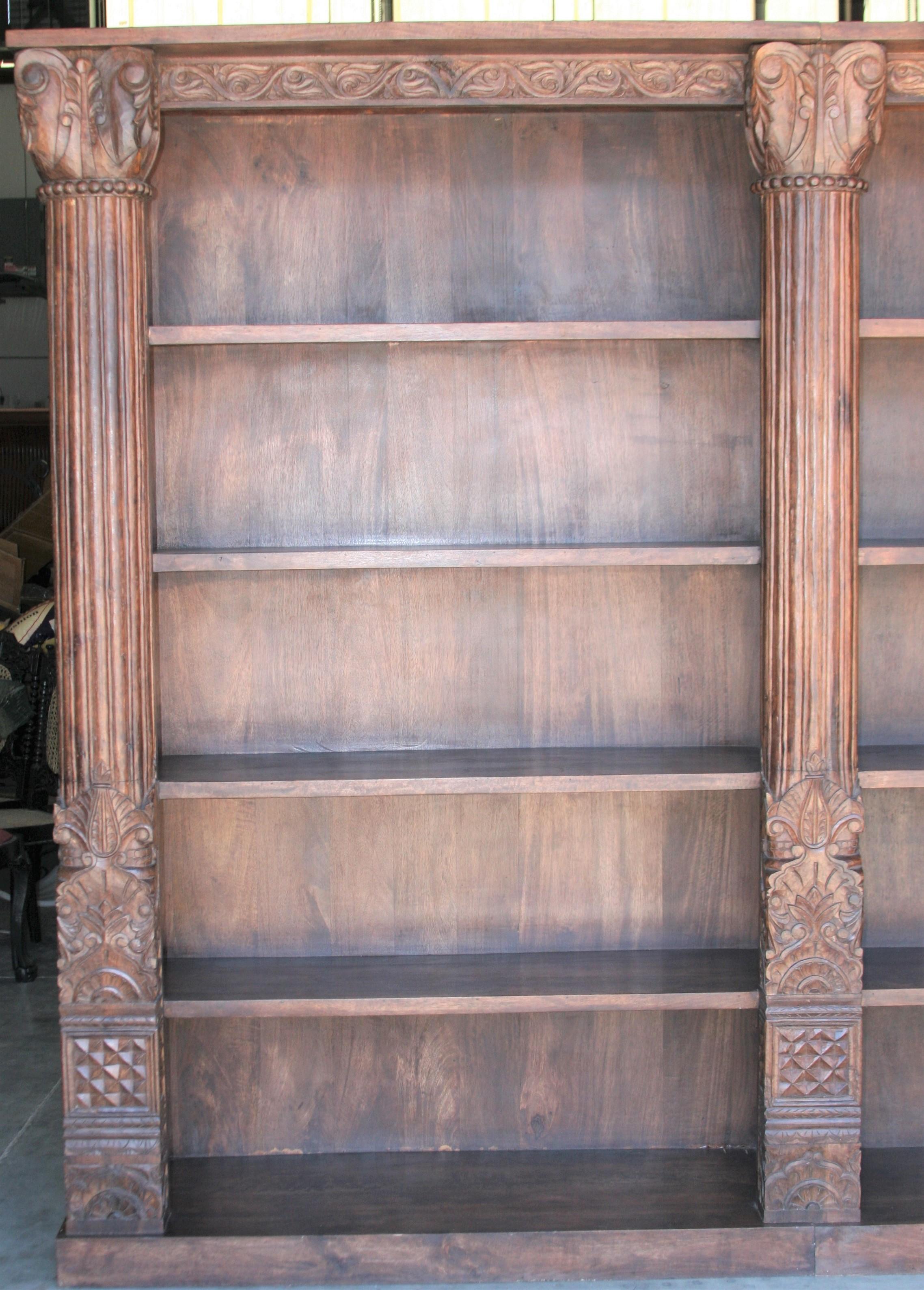 This unique barrister bookcase was custom handcrafted from 19th century architectural elements as columns and doors. The whole piece is solid teak wood. For easy handling it is made up of two parts and when put together it looks like one piece.