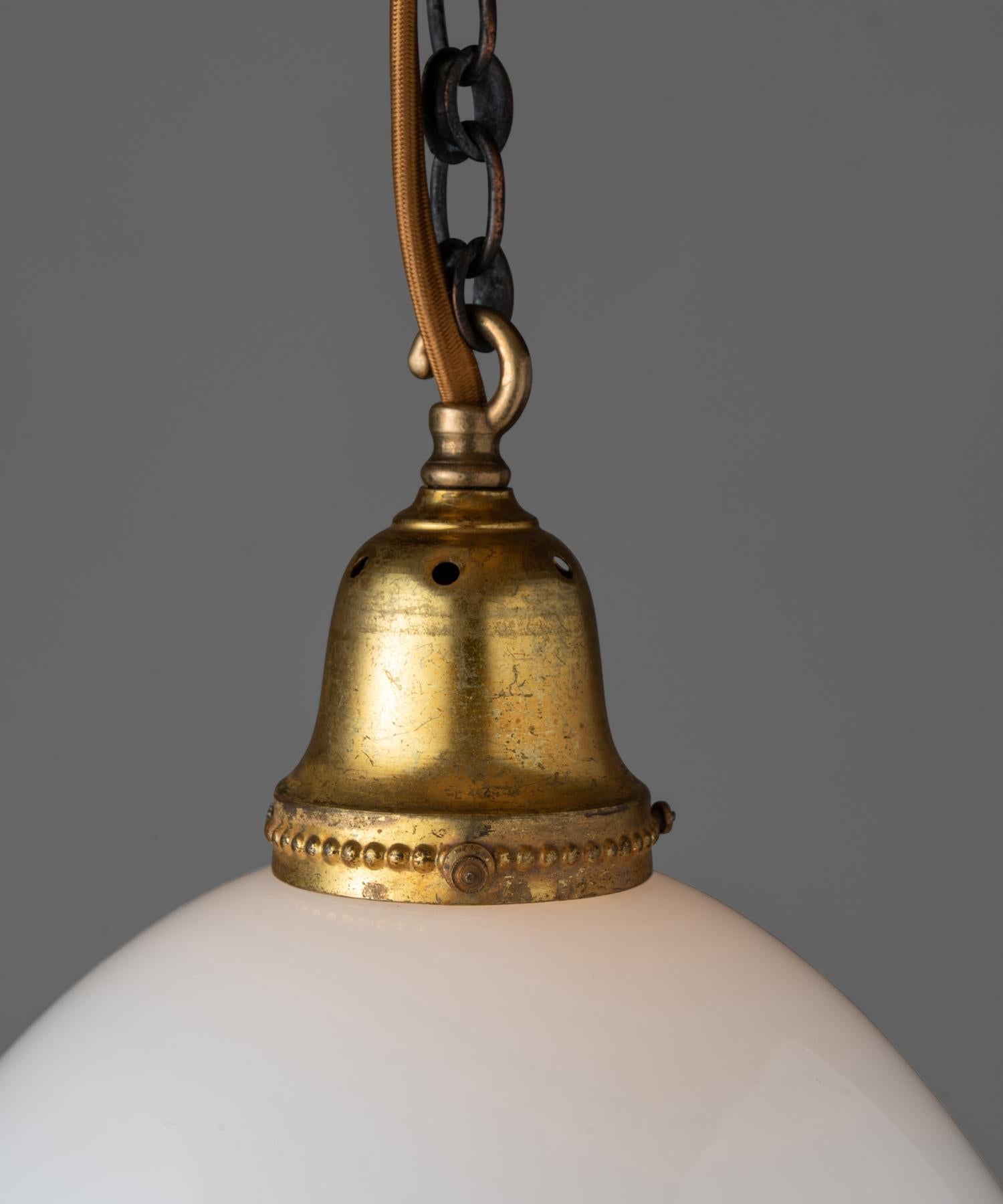 Large scale pendant with opaline top and bottom with brass clasp and gallery.

Measures: 12” diameter x 14” height (fixture).