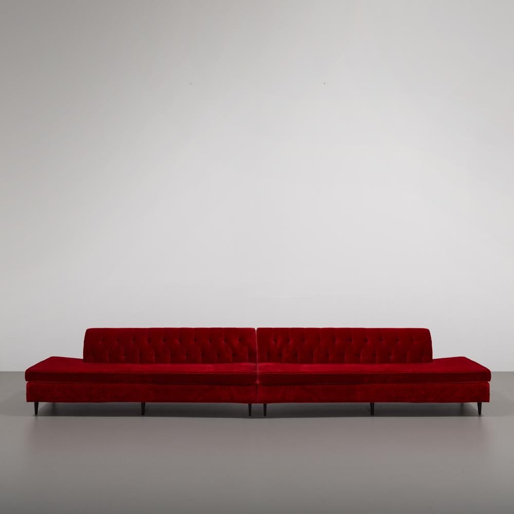 Two part red velvet upholstered button back sofa in original fabric in excellent condition.
An immensely versatile sofa allows the option of using as one long sofa, a corner sofa joined with a end table perhaps or two open ended independent