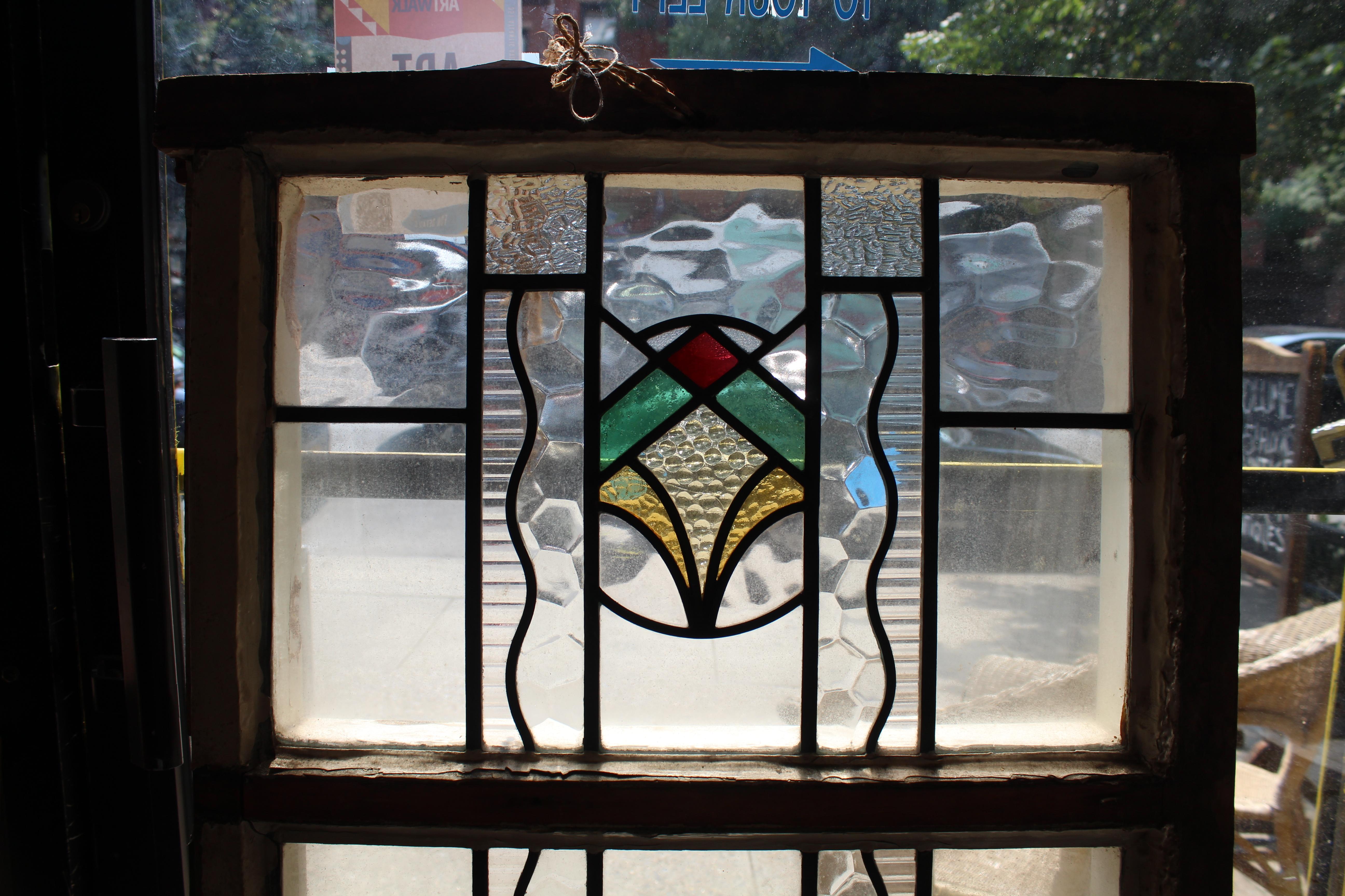Tall window with two stained glass panels. Each piece is colored with leaded design.
Currently housed in a wooden frame - the overall dimensions are for the stained glass and the frame.
Located in NY