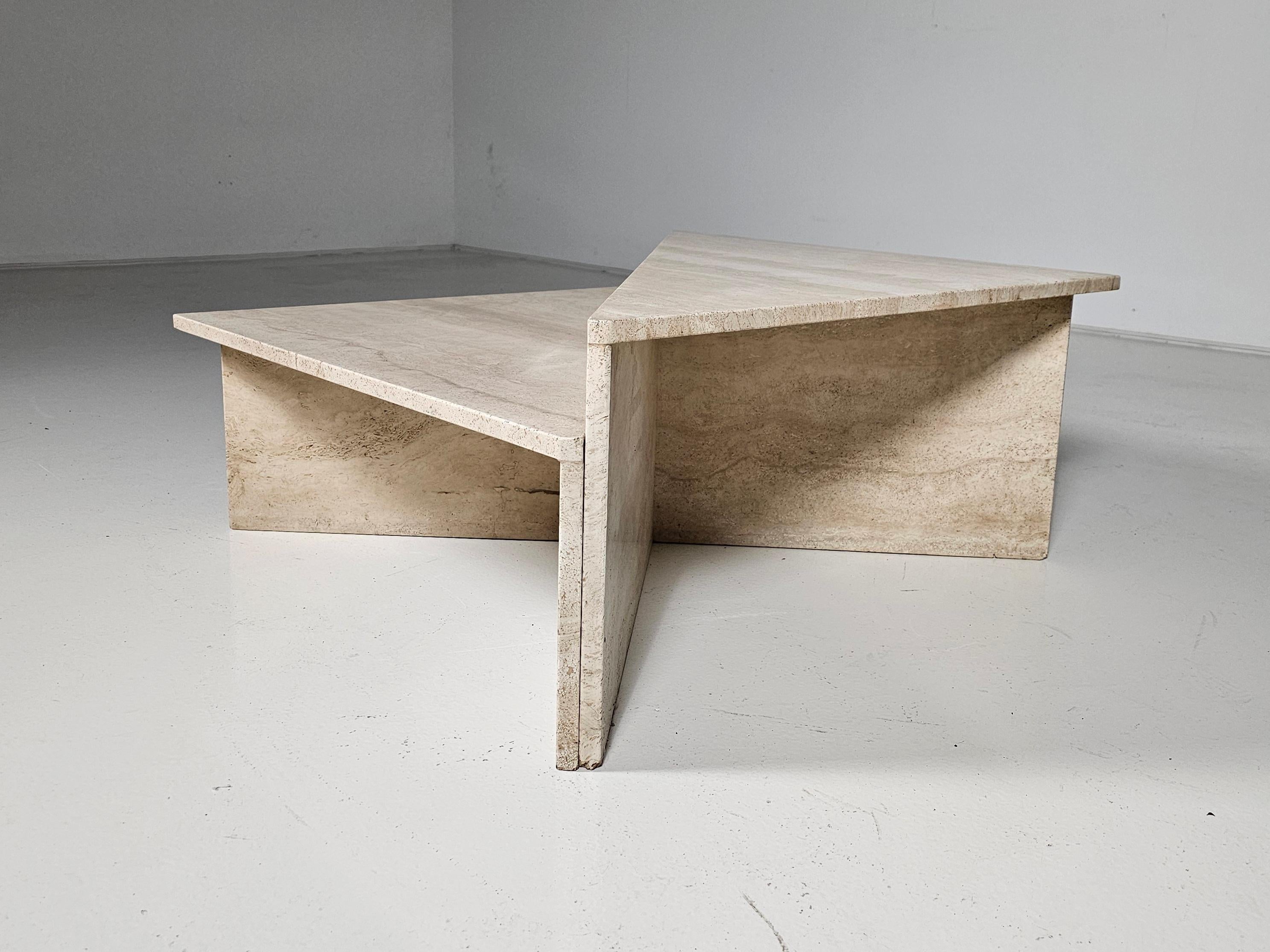 Italian sculptural two-part modern travertine coffee tables from the 1970s. 

It showcases a beautiful travertine grain that offers a soft contrast. The grain gently softens the angular forms with an organic air that's clean and calming. The Modular