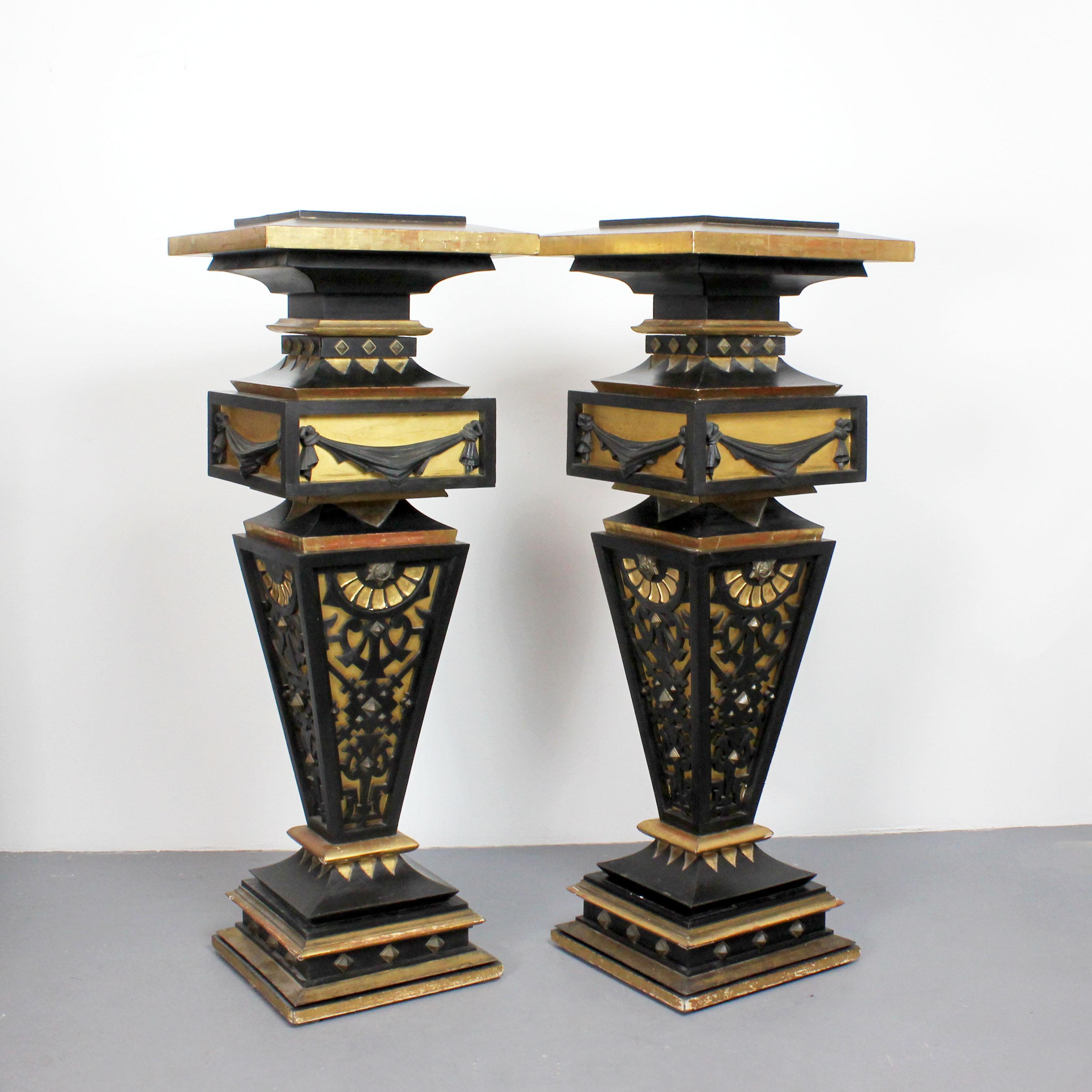 Two pedestals made of wood, gilded and painted black with details in gold bronze.  From France, 19th century.