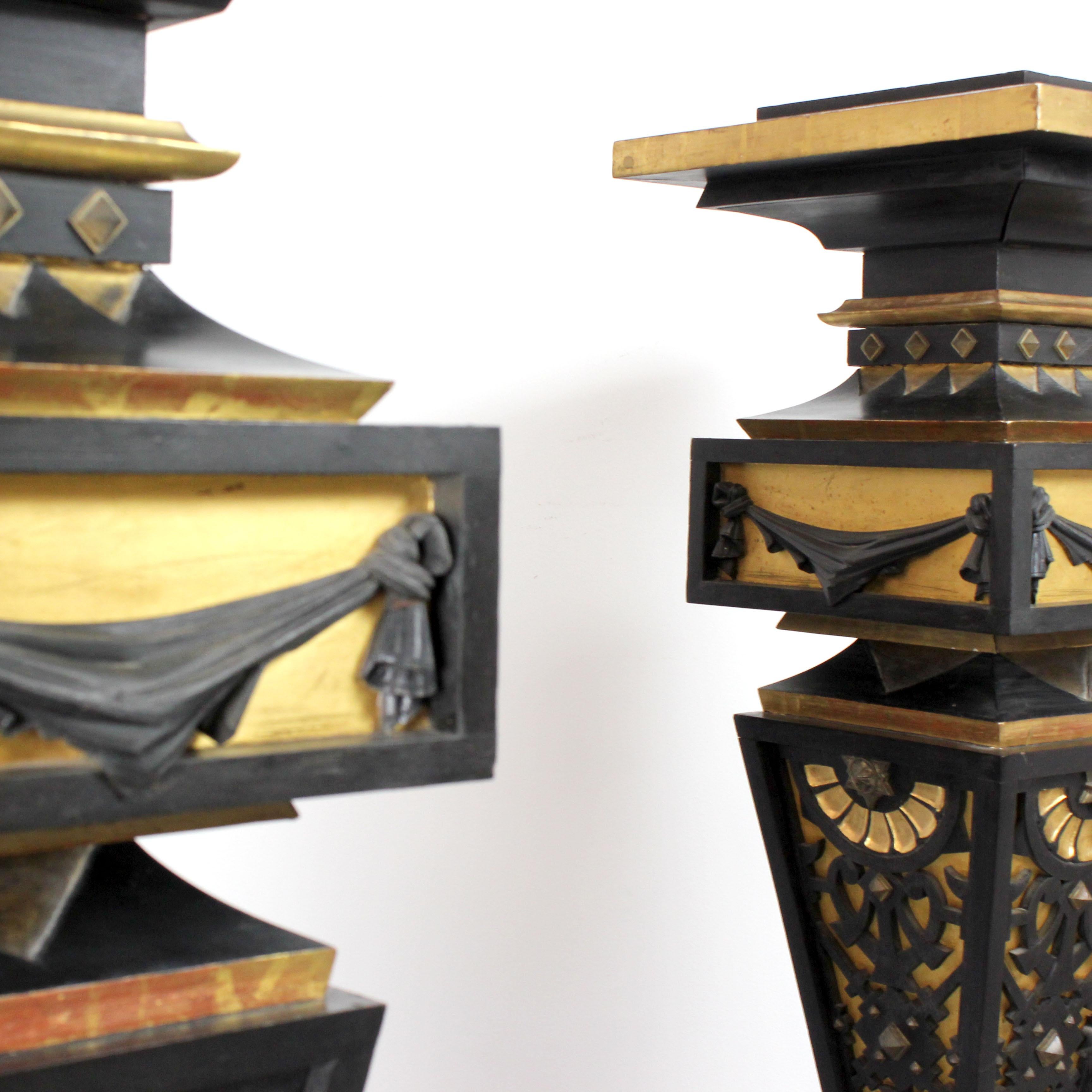French Two pedestals made of wood, gilded and painted black with details in gold bronze For Sale