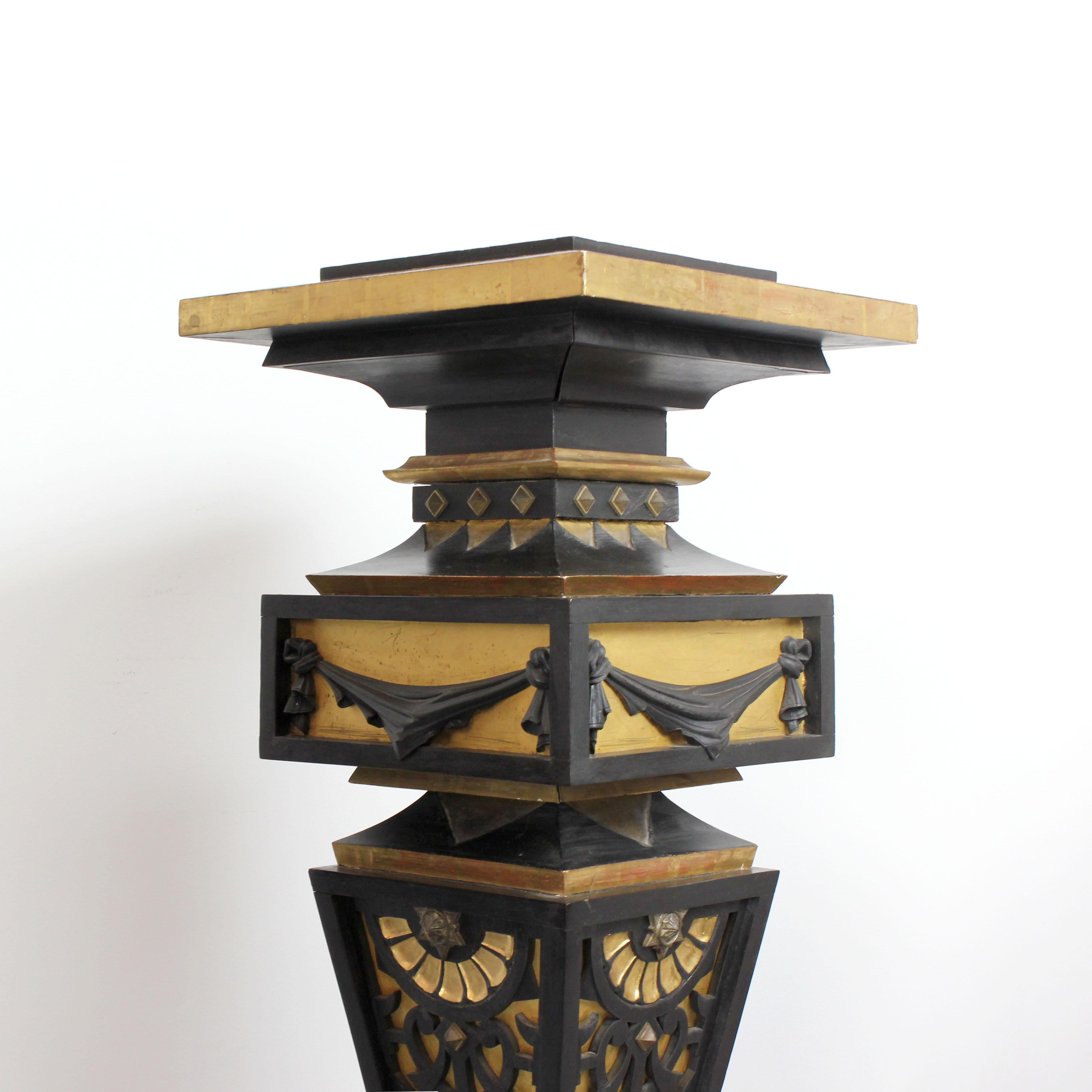 Painted Two pedestals made of wood, gilded and painted black with details in gold bronze For Sale