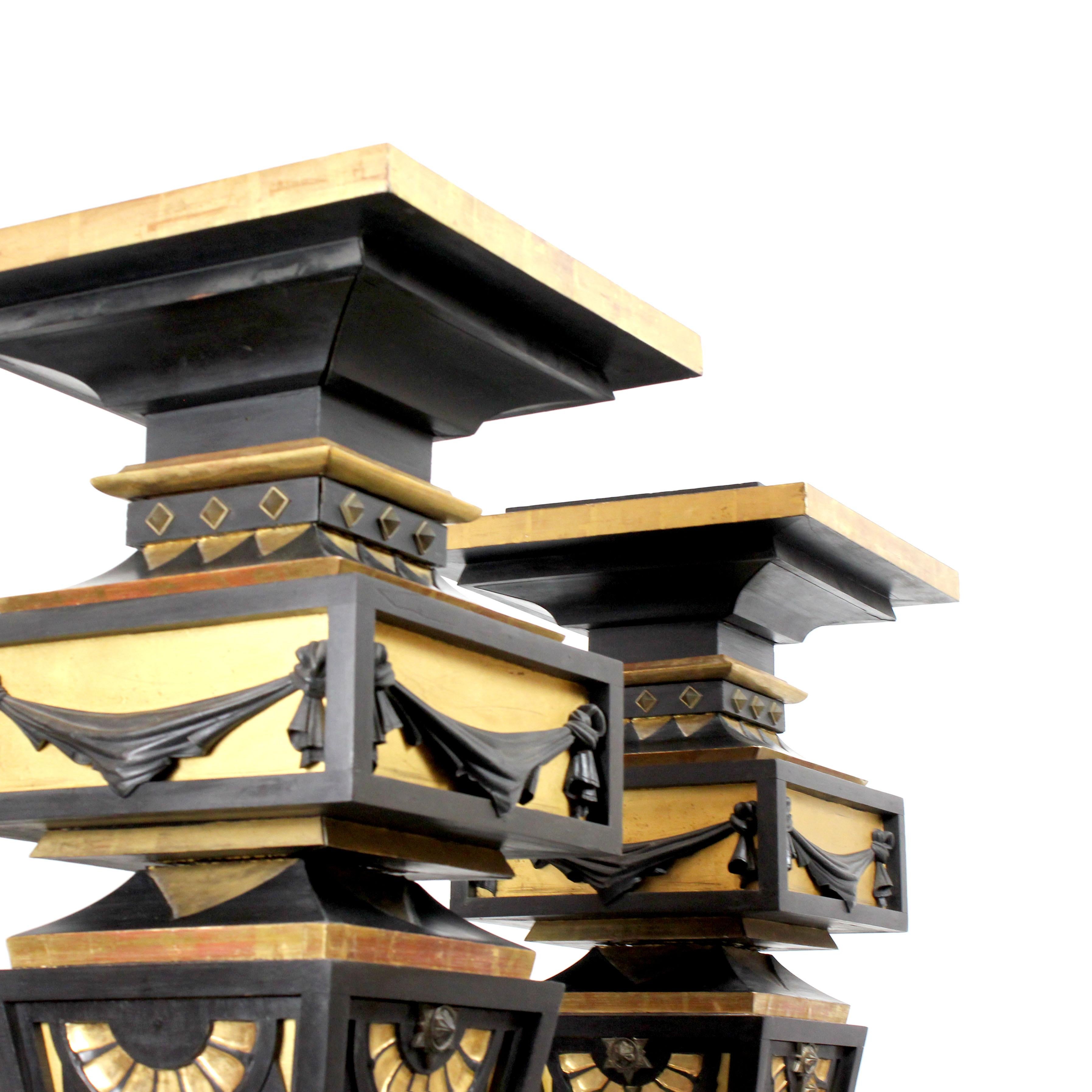 Two pedestals made of wood, gilded and painted black with details in gold bronze For Sale 1
