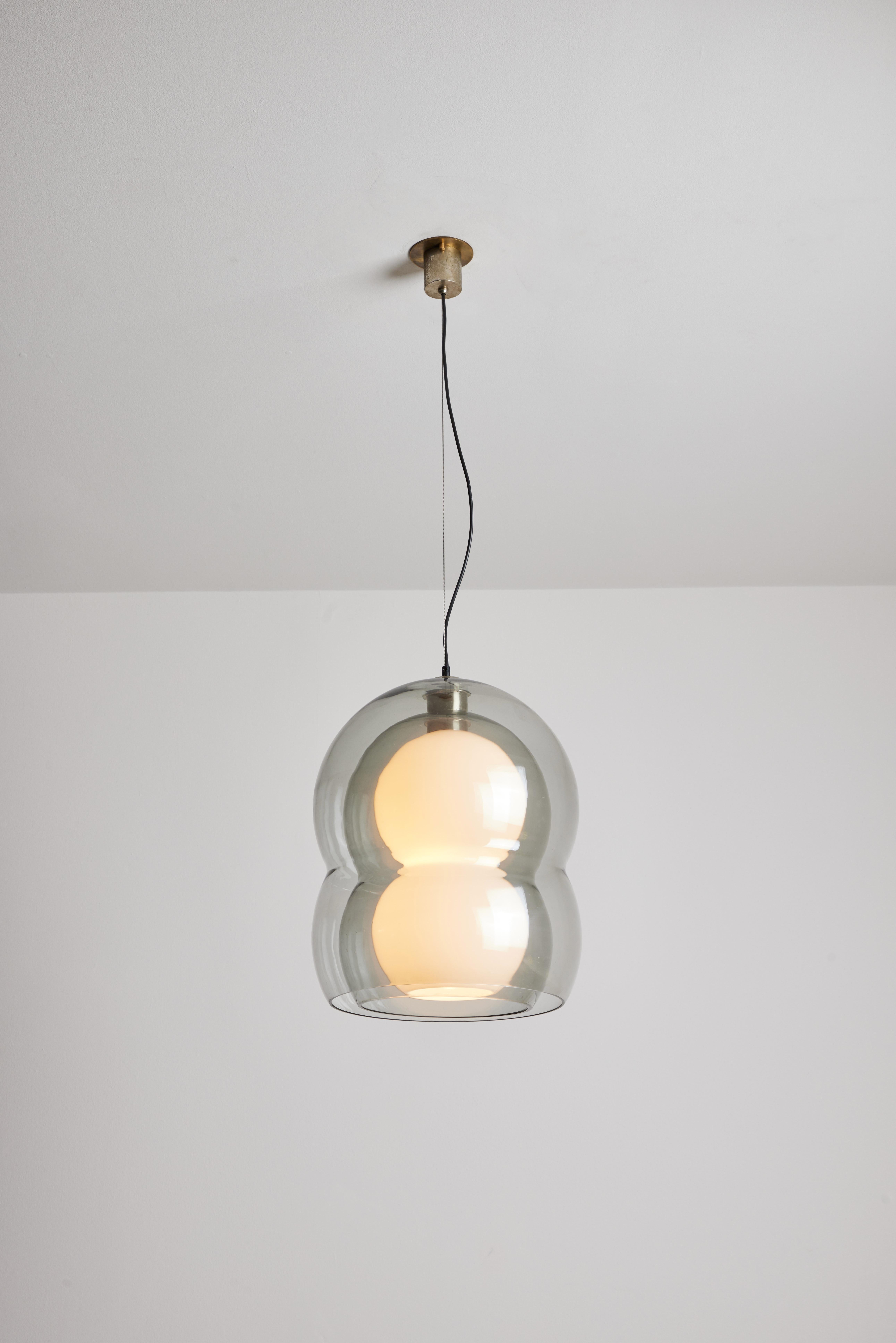 Two pendants by Carlo Nason for Mazzega. Designed and manufactured in Italy, circa 1970s. Glass, brass, nickel. Original canopy, custom brass back plate. We recommend one E27 75w maximum bulb per fixture. Bulbs provided as a one time courtesy.