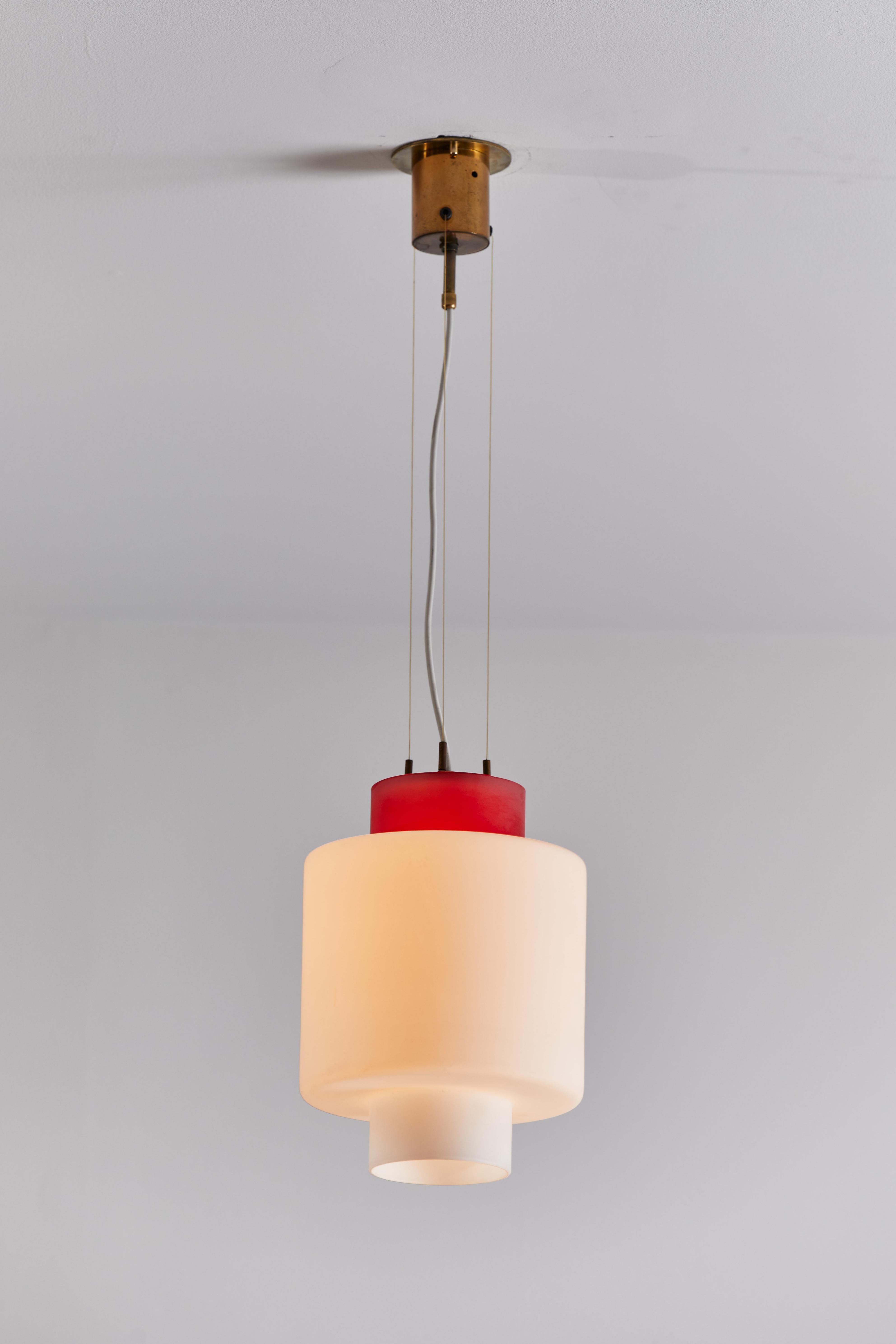 Two pendants by Stilnovo. Manufactured in Italy, circa 1950s. Brushed satin glass diffuser. Brass hardware. Rewired for U.S. standards. Original canopies, custom brass ceiling plates. From the model 8052 series of lights. We recommend one E27 100w