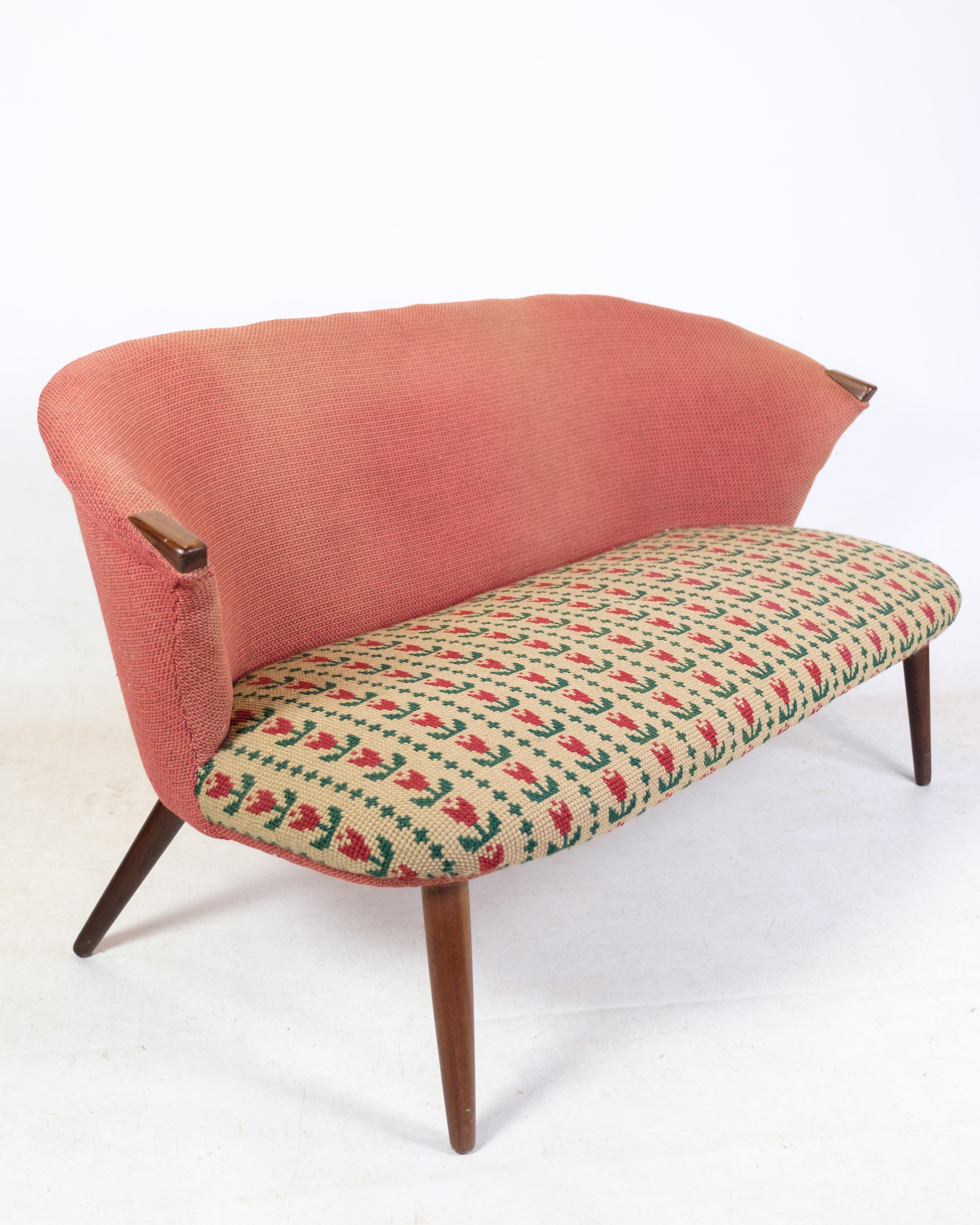Two-person sofa, designed by Bent Møller Jepsen with teak legs and nails covered with patterned fabric from around the 1950s. With original upholstery. Still Excellent sitting comfort. 
Measurements in cm: H:71 W:142 D:50 SH:35