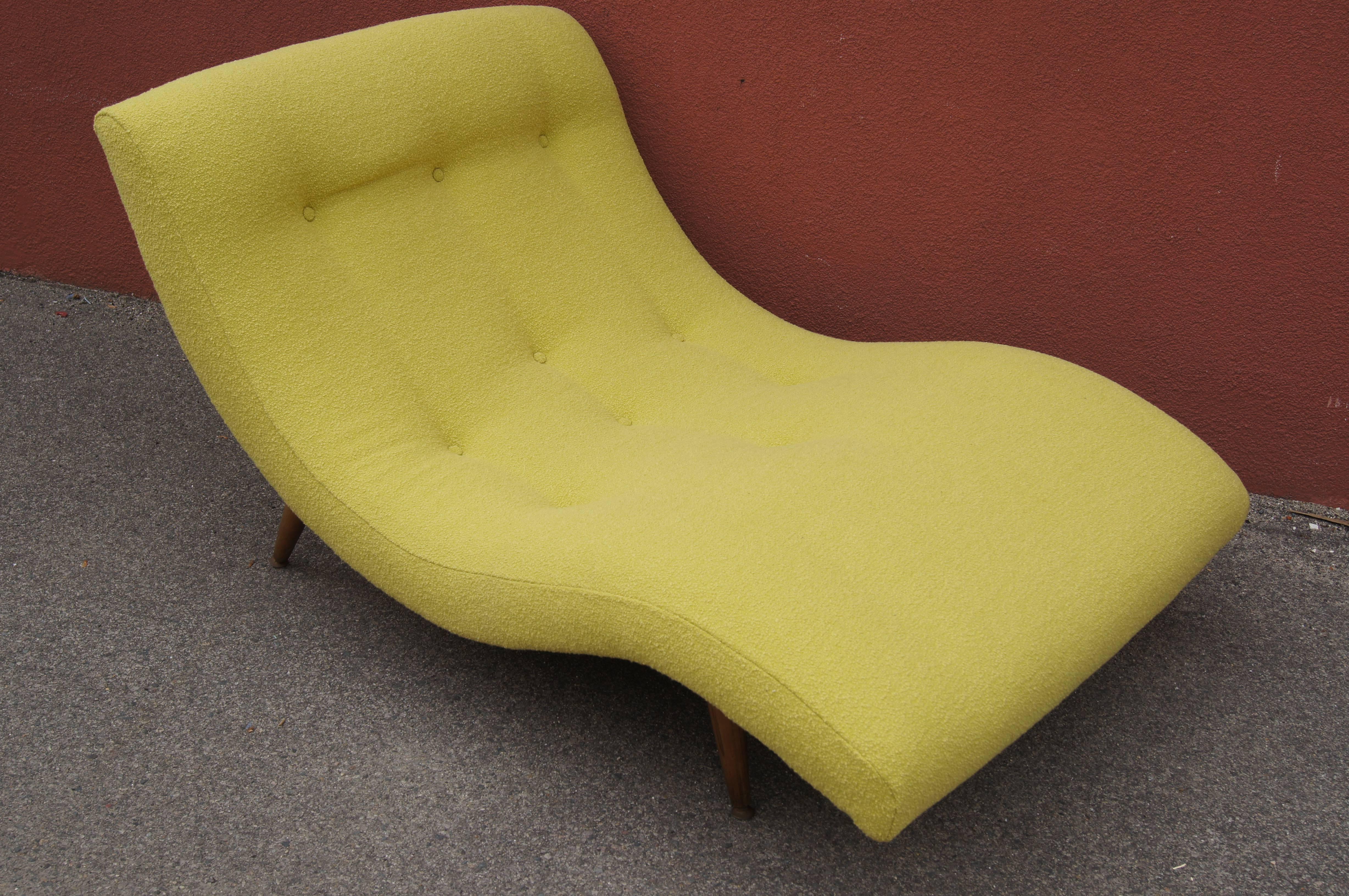 Adrian Pearsall’s design for Craft Associates places a dramatic wave of upholstery on splayed legs of walnut. This chaise longue is large enough for two to lounge comfortably together. It has been reupholstered in Knoll's Classic Bouclé in