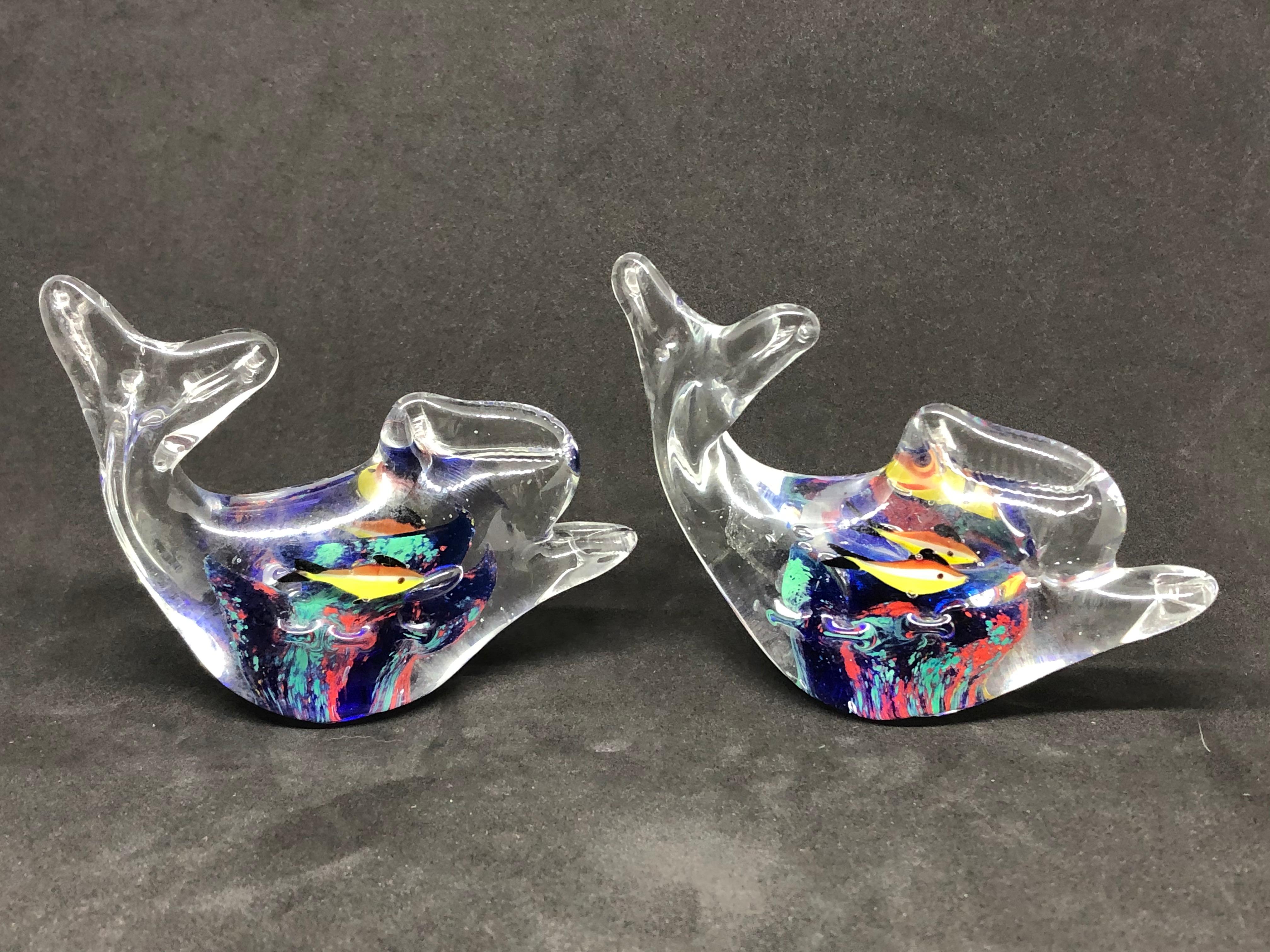 Two beautiful Murano hand blown aquarium Italian art glass paper weights. Showing some multicolored fishes and a coral reef inside a clear glass fish. A beautiful nice addition to your desktop or as a decorative piece in every room.