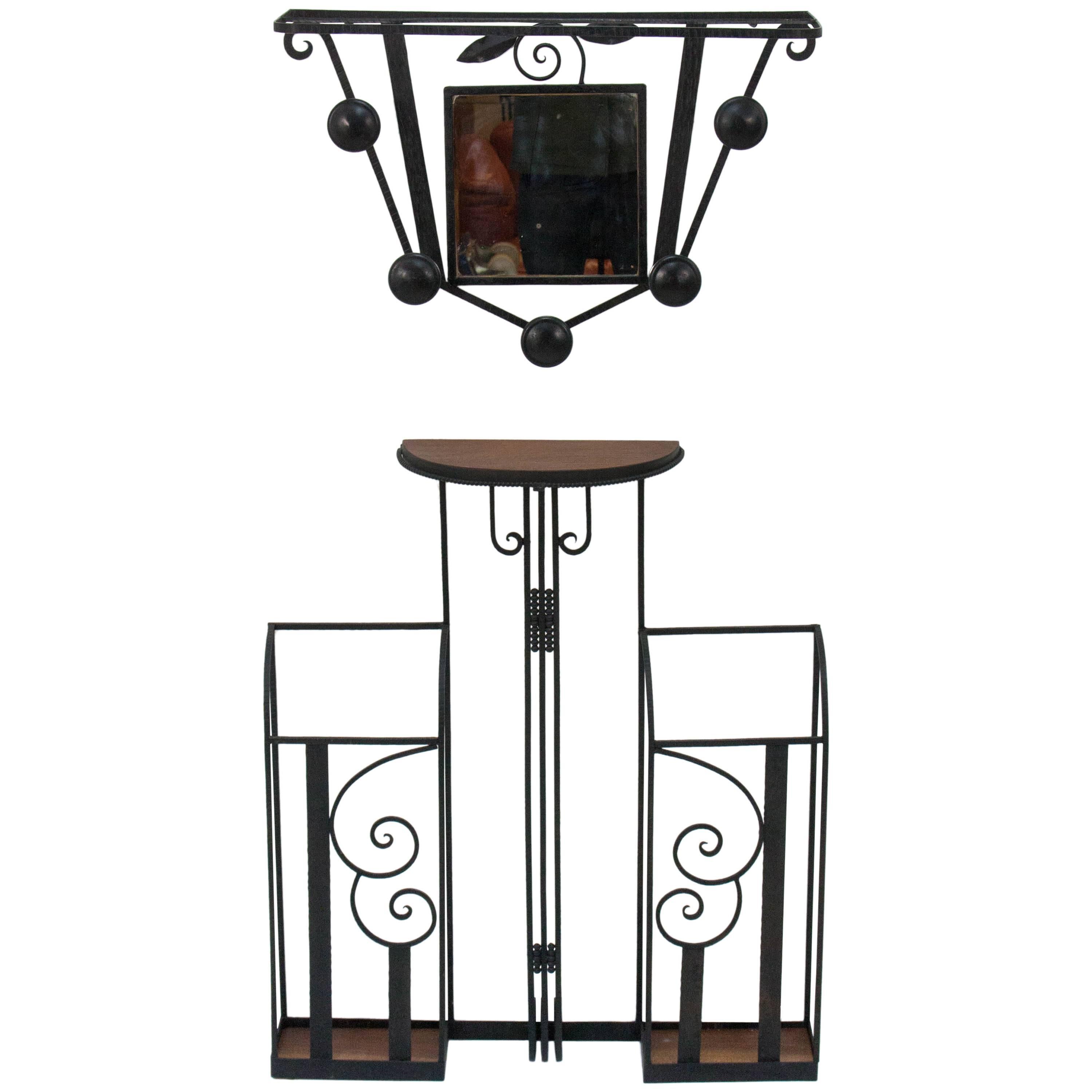 Graceful Art Deco wall-mounted hallway set consisting of an umbrella stand and a coat rack incorporating a small mirror. Cast iron and oak.

The lower umbrella stand part is 86cm tall, 72.5cm wide and 17cm deep, the upper coatrack part is 41cm