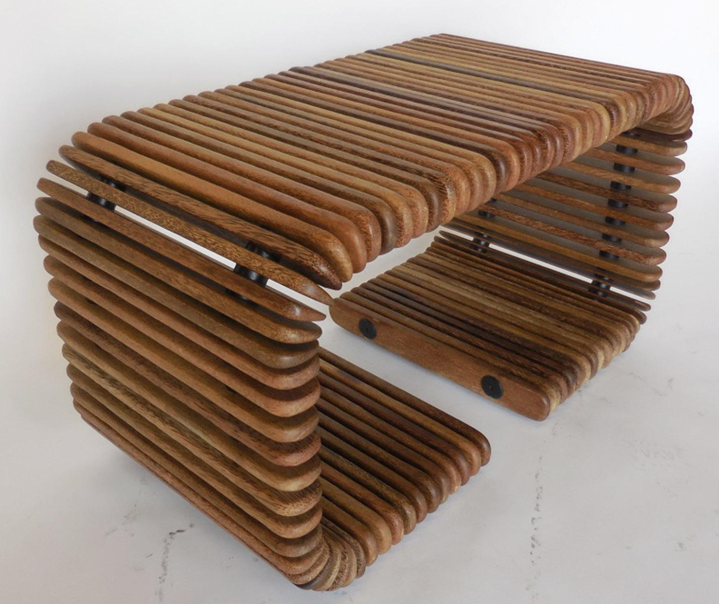 This is a coffee table that can separated into two side tables. Made in Australia, in the 1990s. Constructed by palm wood slices held together by interior metal rods. Beautiful variegated colors throughout sustainable tropical palm wood. The look is