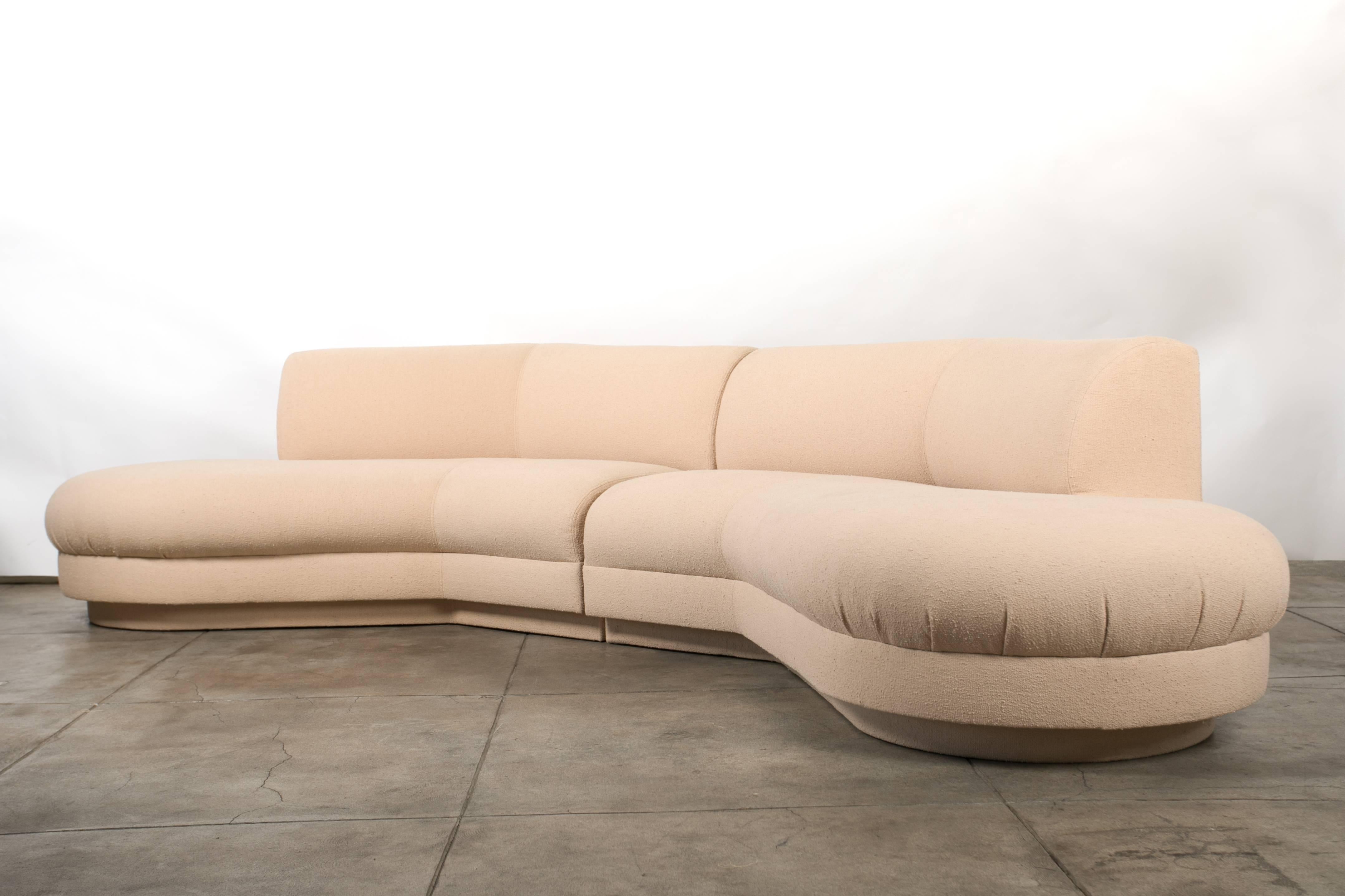 A two-piece Vladimir Kagan-designed curved sectional for Directional, reupholstered in a caramel-colored bouclé. The two interlocking sections have a rounded backrest and open sides, with segmented top-stitched upholstery emphasizing the interior